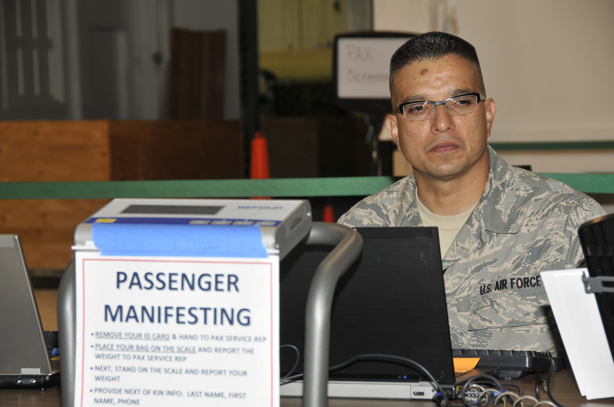 California Air National Guard Master Sgt. Mark Vindiola, NCO in charge of the cargo movement operating system, weighs passengers and bags to ensure that aircraft weight limits are not exceeded, at Moffett Federal Airfield, Calif., Oct., 1, 2011. Vindiola, assigned to the 129th Logistics Readiness Squadron is taking part in the 129th Rescue Wing operational readiness exercise. (Air National Guard photo by Staff Sgt. Kim E.Ramirez/Released)

