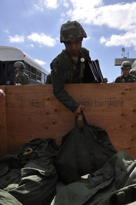 California Air National Guardsman Capt. Kenley Lok with the 130th Rescue Squadron grabs his deployment bag while participating in a Phase 1 Operational Readiness Exercise at Moffett Federal Airfield, Calif., Oct. 1, 2011.  (Air National Guard Photo by Airman 1st Class John Pharr)