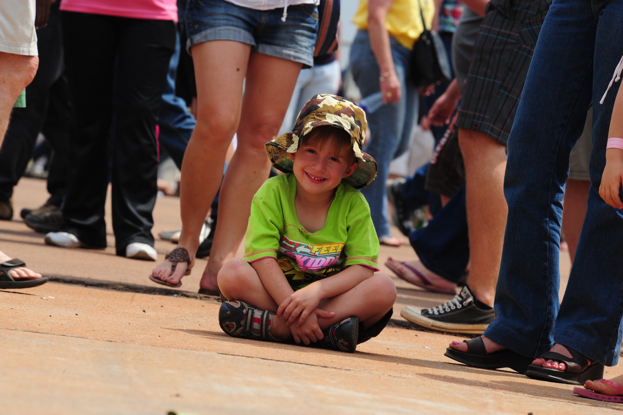 PRETORIA, South Africa - A young child takes a break while waiting to tour the KC-135 static display during the 2011 Air Show & Lifestyle Expo at Waterkloof Air Force Base, Oct. 1. From the moment the air show opened both the KC-135 and C-17 static displays had lines of visitors waiting more than 45 minutes to view the U.S. Air Force aircraft. (U.S. Air Force photo by Tech. Sgt. Todd Wivell)