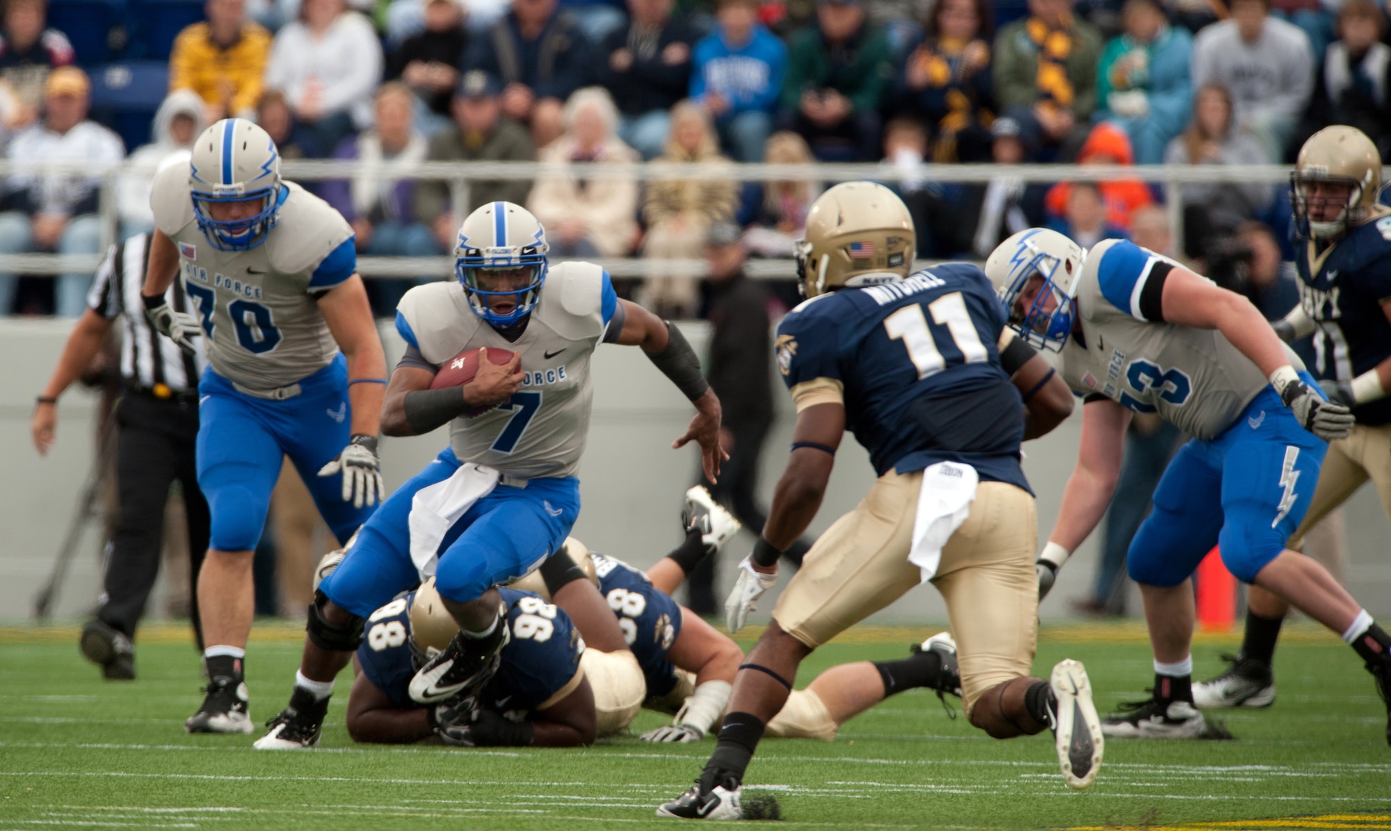 Air Force quarterback Tim Jefferson runs up the middle as the Falcons take on the Midshipmen of Navy Saturday, Oct. 1, 2011 at the Naval Academy's Jack Stephens Field. The Falcons dominated the first half, but almost let go of the game in the second after the Mids outscored them 25-7. The Falcons won 35-34 in overtime after the Mids kicker Jon Teague missed their point after attempt.  (U.S. Air Force photo/Russ Scalf)