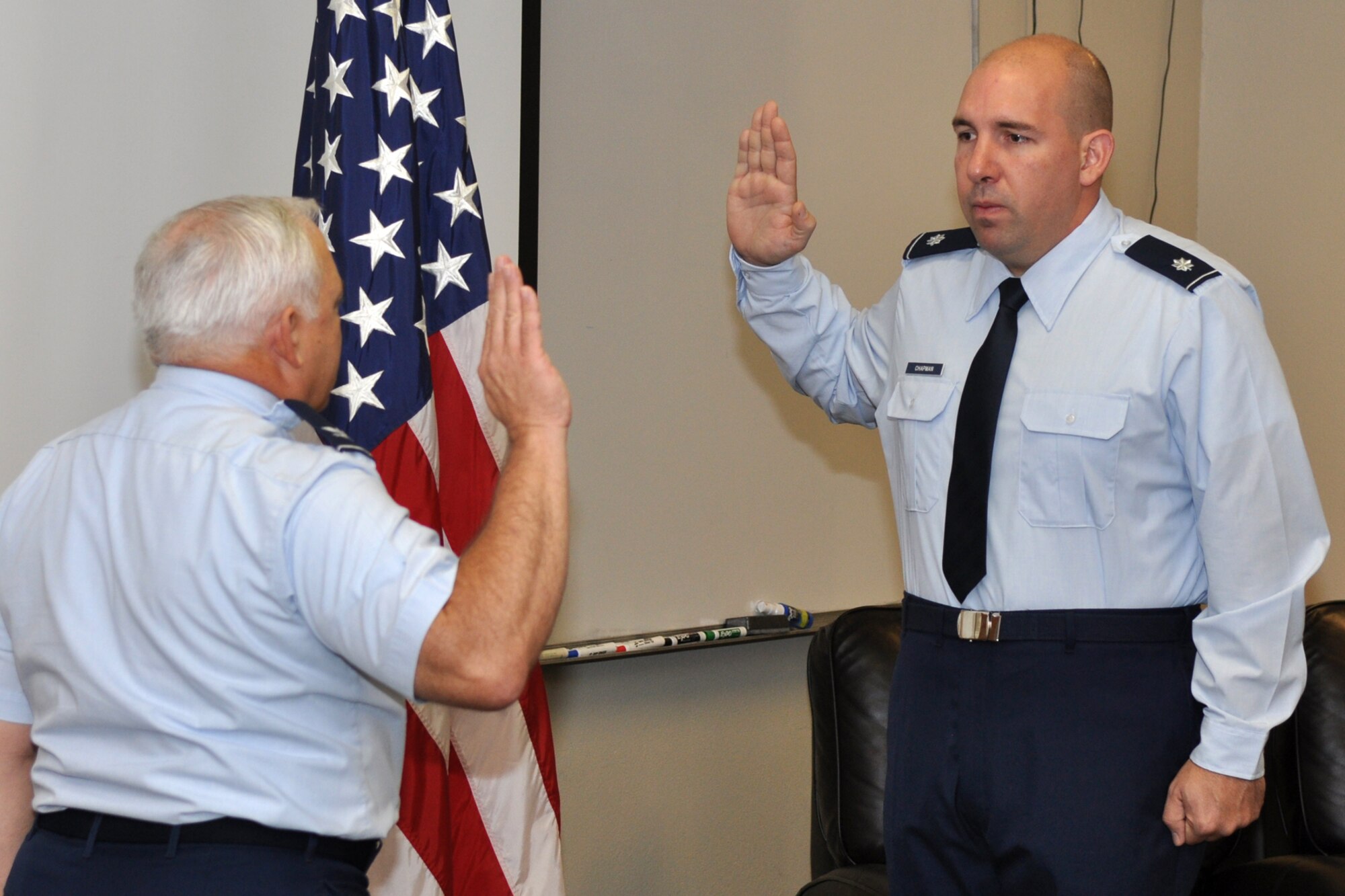 Lt. Col. Charles B. Chapman III, the commander of the 307th Civil Engineer Squadron reaffirms his oath during a promotion ceremony at Barksdale Air Force Base, La., Oct. 1, 2011. The presiding official for the ceremony was Col. Kevin Wolfe, the 307th Mission Support Group commander. (U.S. Air Force photo by Master Sgt. Jeff Walston/Released)  