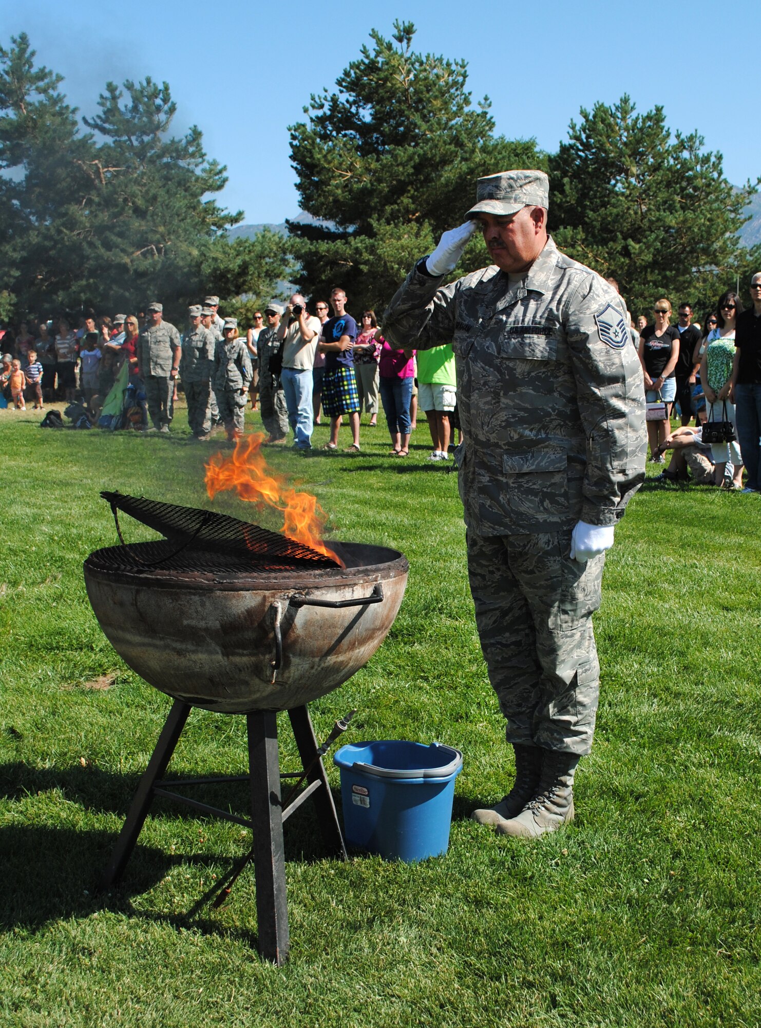 Master Sgt. Dave Graham, of the 419th Honor Guard, salutes the flag after he placed it in a fire as part of a flag retirement ceremony. (U.S. Air Force photo/Airman 1st Class Crystal Charriere)