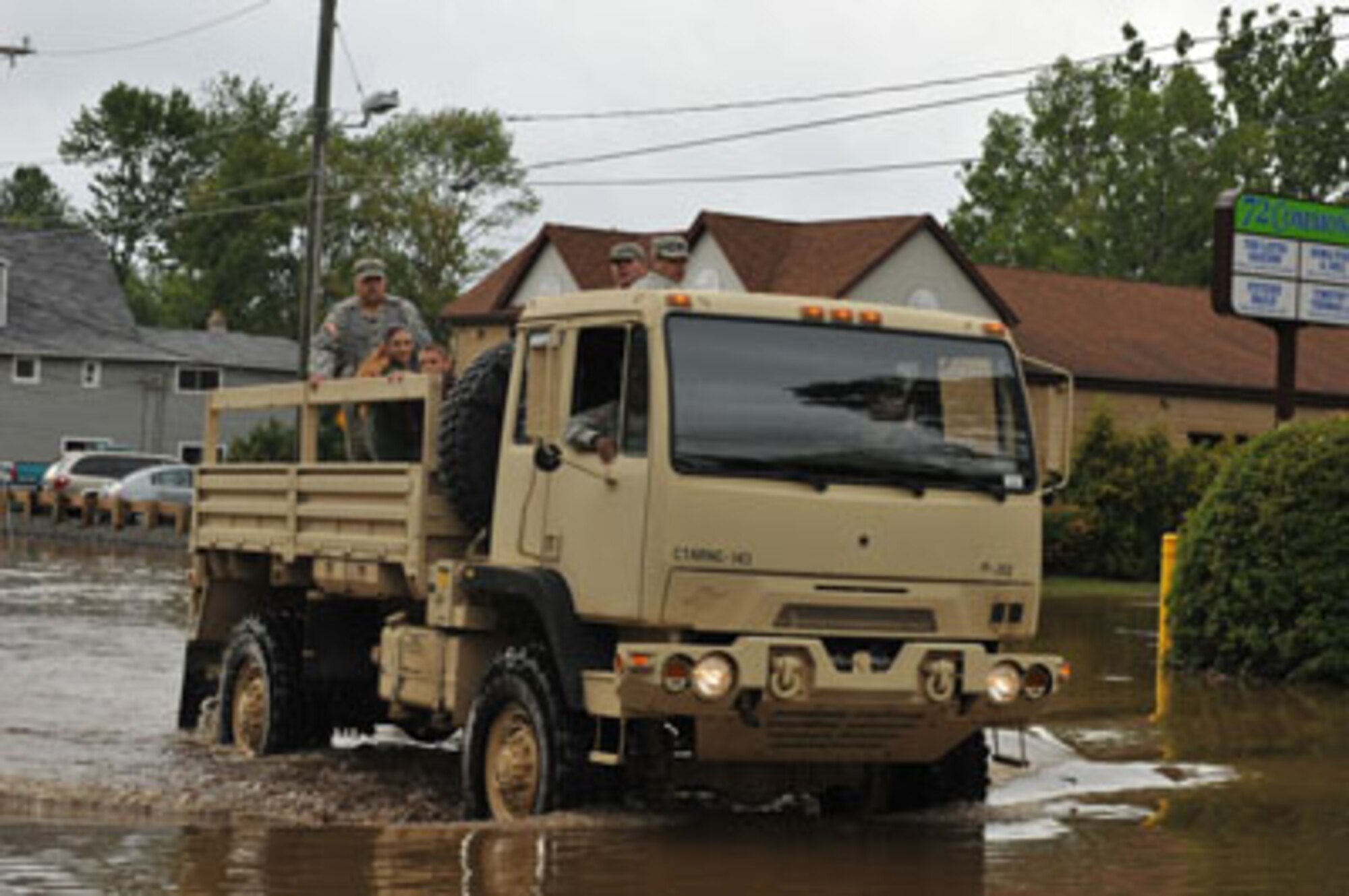 Members of the 143rd Military Police Company, Connecticut Army National Guard, help a Bristol family stranded in their home by flood waters to safety on Aug. 28, 2011 after flooding caused by Irene. (Photo courtesy 143rd Military Police Company, CTARNG)