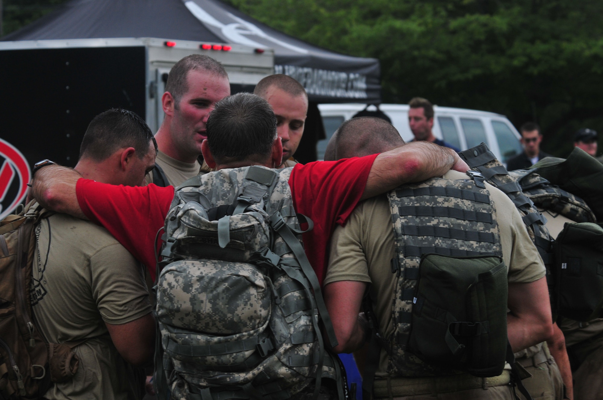 Chief Master Sgt. Tim Shaw (red t-shirt) huddles with exhausted members of the Connecticut Air National Guard Emergency Service Team during the annual Connecticut SWAT Challenge event at the West Hartford MDC Reservoir Aug. 25, 2011. The Guard team took 22nd place overall in the annual competition and earned the Top Military Team award for the second consecutive year. (U.S. Air Force photo by Tech. Sgt. Erin McNamara)