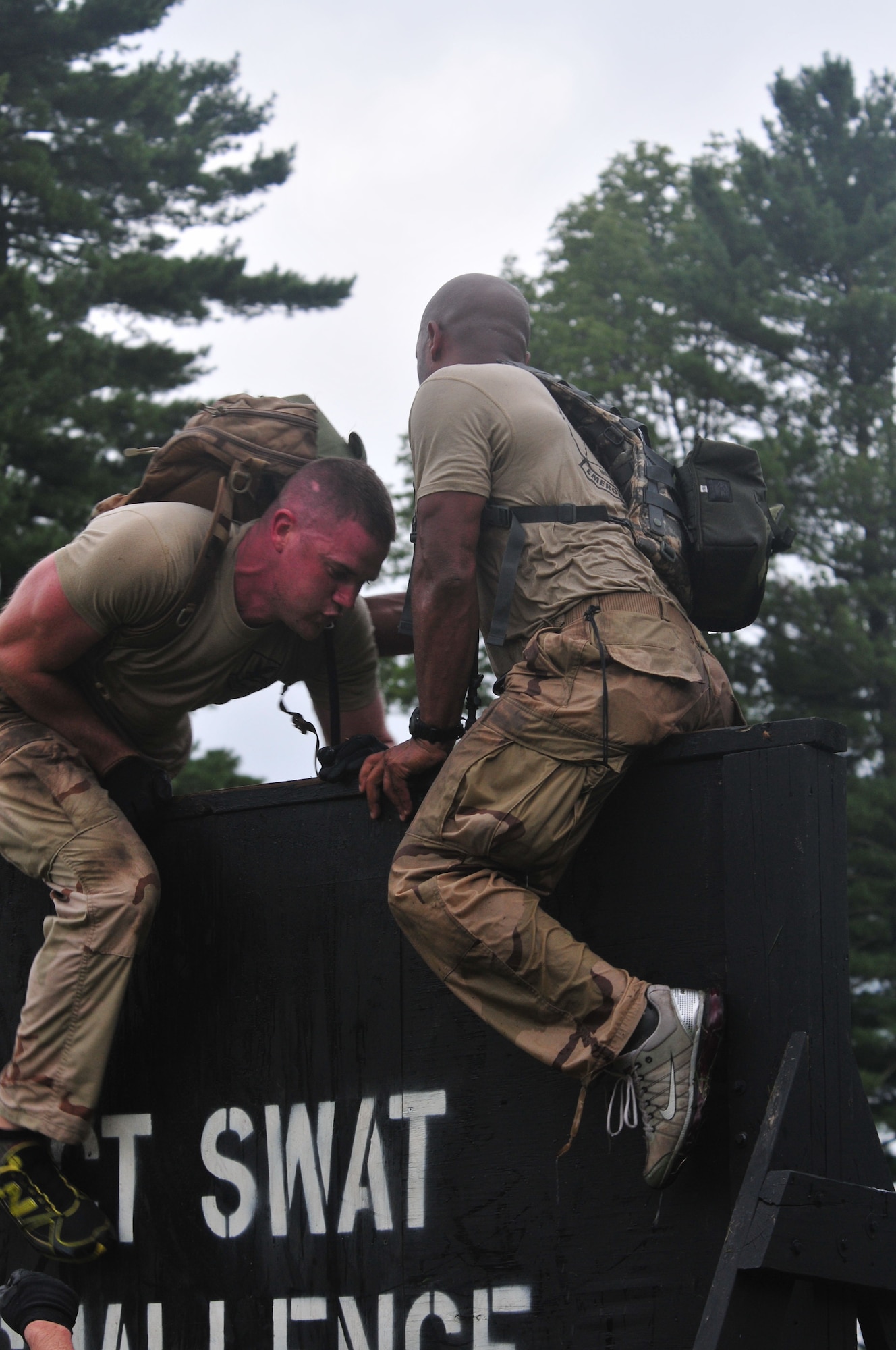 Staff Sgt. Brian Davies (left), 103rd Security Forces Squadron, and Staff Sgt. Victorious Felder from 103rd Air and Space Operations Group scale a wall during a Connecticut SWAT Challenge event at the West Hartford MDC Reservoir in Conn. Aug. 25, 2011. The Guard team took 22nd place overall in the annual competition. (U.S. Air Force photo by Tech. Sgt. Erin McNamara)