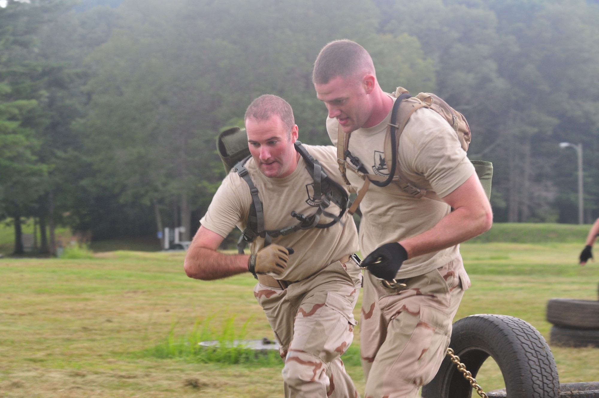 Staff Sgt. Ray Ryan (left) and Staff Sgt. Brian Davies, both from the 103rd Security Forces Squadron, pull more than just their own weight as members of the Connecticut Air National Guard Emergency Service Team during a Connecticut SWAT Challenge event at the West Hartford MDC Reservoir Aug. 25, 2011. The Guard team took 22nd place overall in the annual competition. (U.S. Air Force photo by Tech. Sgt. Erin McNamara)