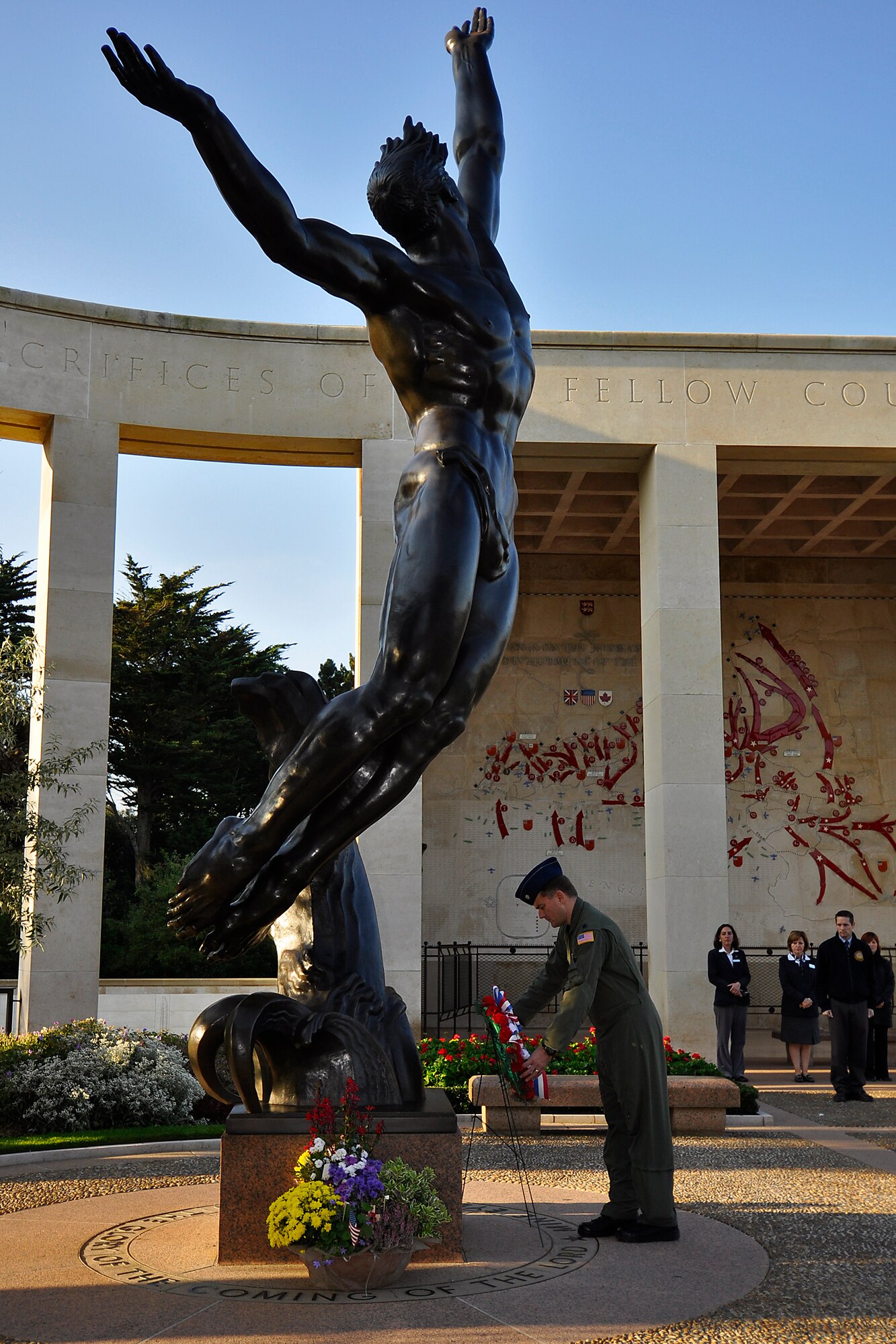 Lt. Col. Dennis Duffy, 732nd Airlift Squadron commander, places a wreath at the base of a 22-foot bronze statue, "The Spirit of American Youth Rising from the Waves" at the Normandy American Cementary Sept. 23, 2011. The cemetery is situated on a cliff overlooking Omaha Beach and the English Channel just east of St-Laurent-sur-Mer, France. Duffy was part of a contingent of Reserve Airmen from the 514th Air Mobility Wing who repatriated the wreckage of a bomber that crashed in World War II. The B-17 Flying Fortress spent more than half a century in a French farmers barn before being turned over to the Airmen. The 514th Air Mobility Wing is stationed at Joint Base McGuire-Dix-Lakehurst, N.J.