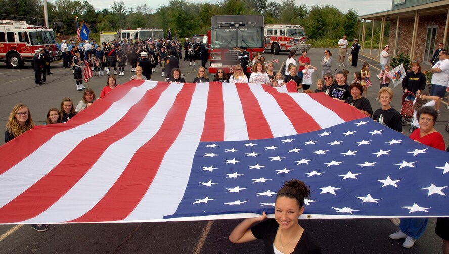 Members of Riley’s Dance School out of Enfield, Conn., display an American flag during a parade sponsored by the Enfield Fire Department, commemorating the 10th anniversary of the terrorist attacks of 9/11 in Enfield, Conn., Sept. 11, 2011. Riley’s Dance School has been a major contributor and participant in this event since its inception in 2006. (U.S. Air Force photo by Tech. Sgt. Tedd Andrews)