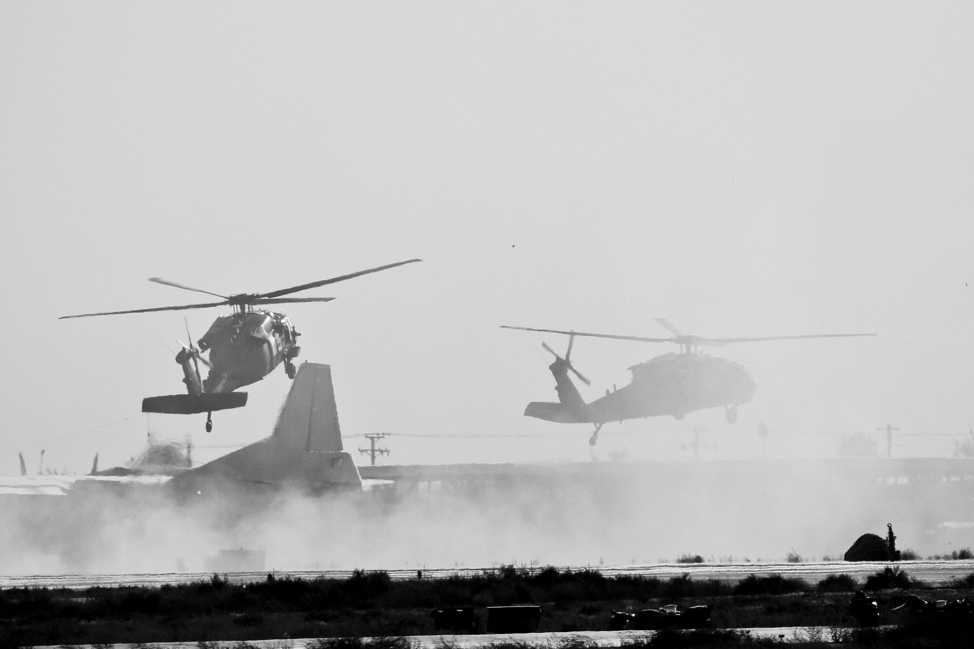 BAGRAM AIRFIELD, Afghanistan -- Two Army UH-60 Black Hawk helicopters from Task Force Falcon lift off from here Sept. 30, 2011. The helicopter’s mission is to provide air assault, general support, aeromedical evacuation, command and control and special operations support to combat and stability and support operations. Air Force aircraft and ground personnel often work hand-in-hand with the Black Hawks to achieve mission objectives in Afghanistan. (U.S. Air Force photo/Tech Sgt. Matt Hecht)