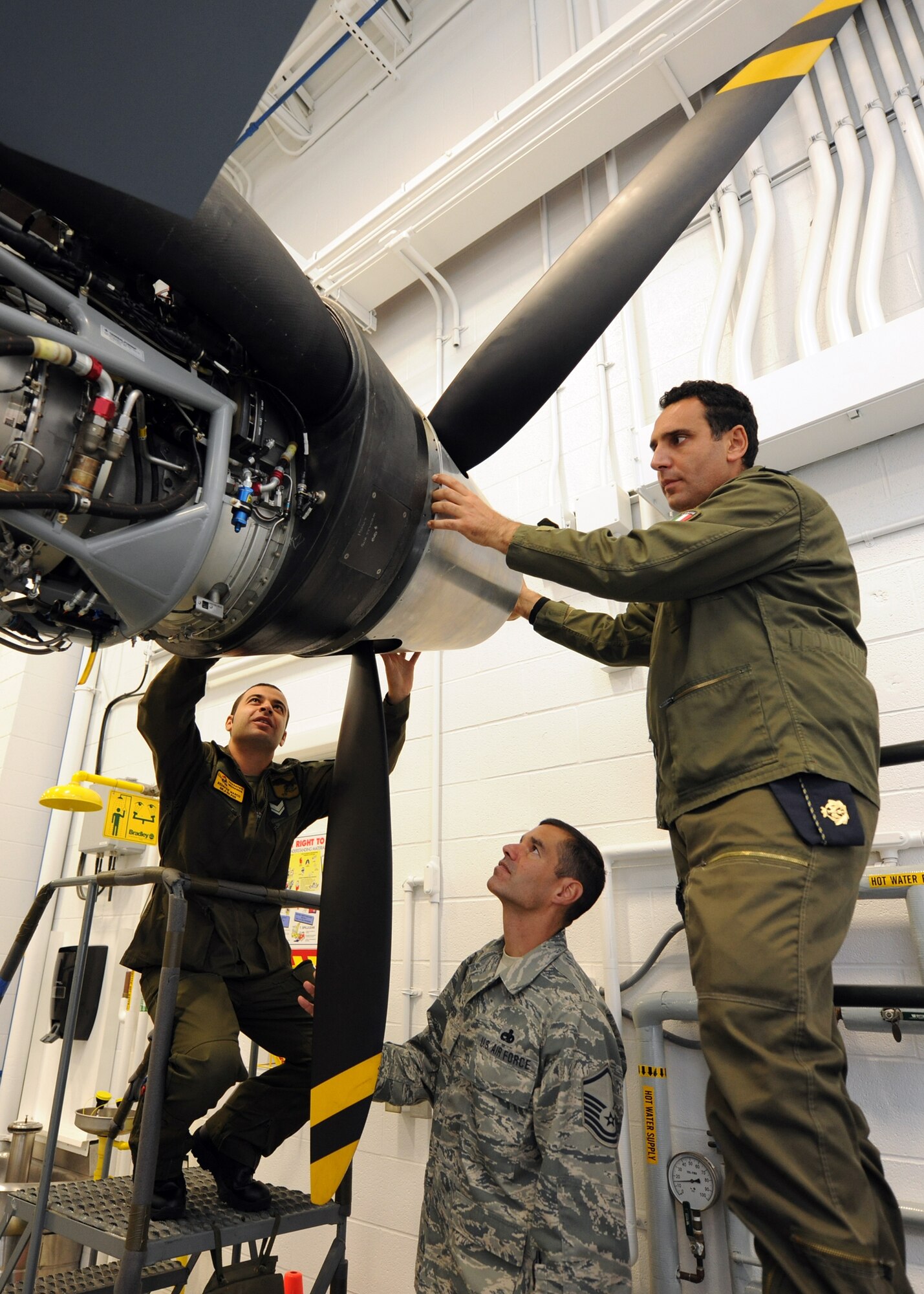Italian Air Force Chief Warrant Officer Lorenzo Scafuto and Staff Sgt. Marco Redavide work together on a MQ-9, while receiving feedback from their instructor Master Sgt. Scott Simpson at the Field Training Detachment (FTD) in Syracuse NY, on 20 Sept 2011.  Scafuto and Redavide are the first Italian Air Force members to receive formal maintenance training on the MQ-9.  They are part of the 100th graduating class from the 174 FW FTD, which is the sole formal MQ-9 maintenance training facility in the U.S. Air Force. (Photo by Staff Sgt Ricky Best)