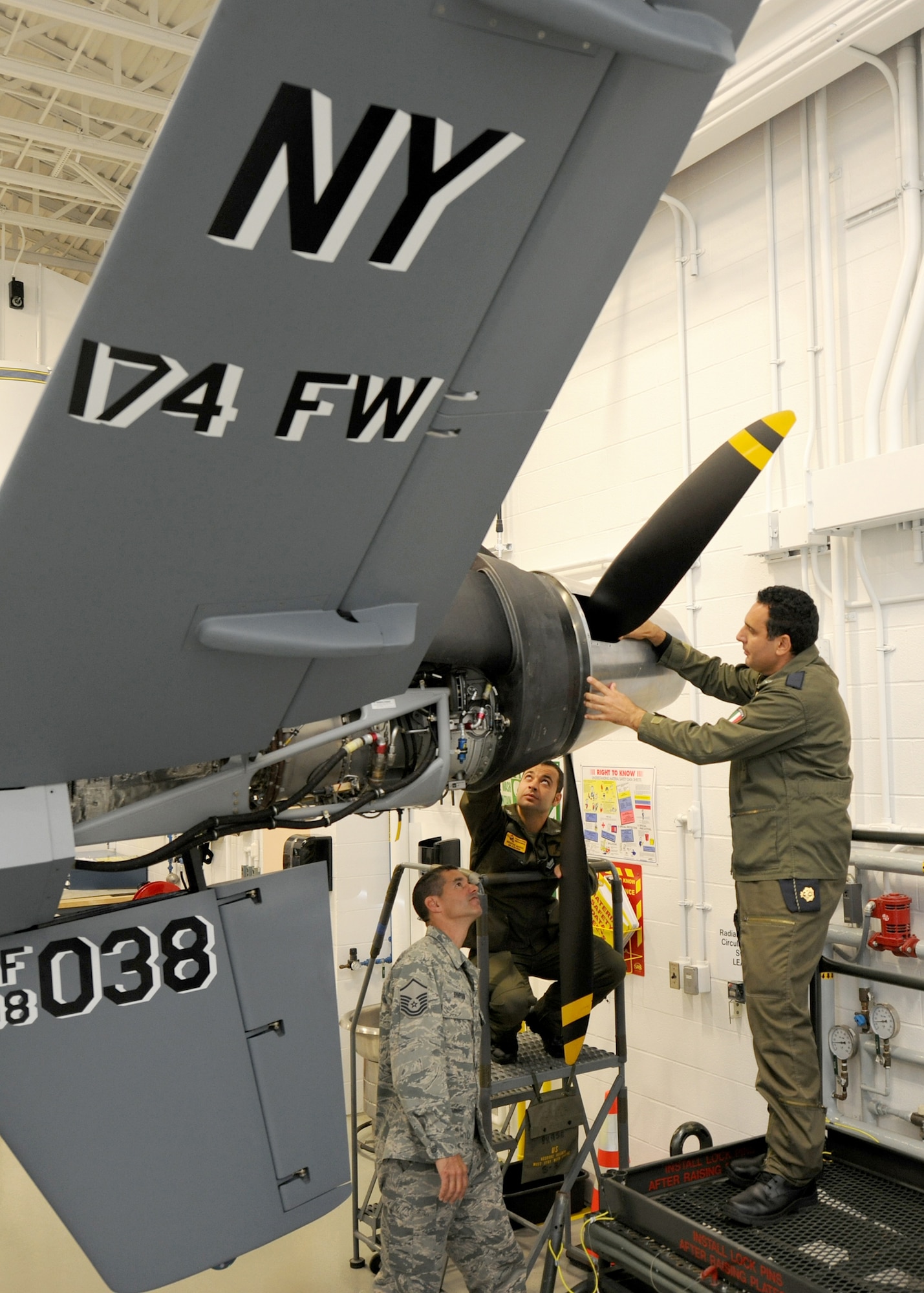 Italian Air Force Chief Warrant Officer Lorenzo Scafuto and Staff Sgt. Marco Redavide work together on a MQ-9, while receiving feedback from their instructor Master Sgt. Scott Simpson at the Field Training Detachment (FTD) in Syracuse NY, on 20 Sept 2011.  Scafuto and Redavide are the first Italian Air Force members to receive formal maintenance training on the MQ-9.  They are part of the 100th graduating class from the 174 FW FTD, which is the sole formal MQ-9 maintenance training facility in the U.S. Air Force. (Photo by Staff Sgt Ricky Best)