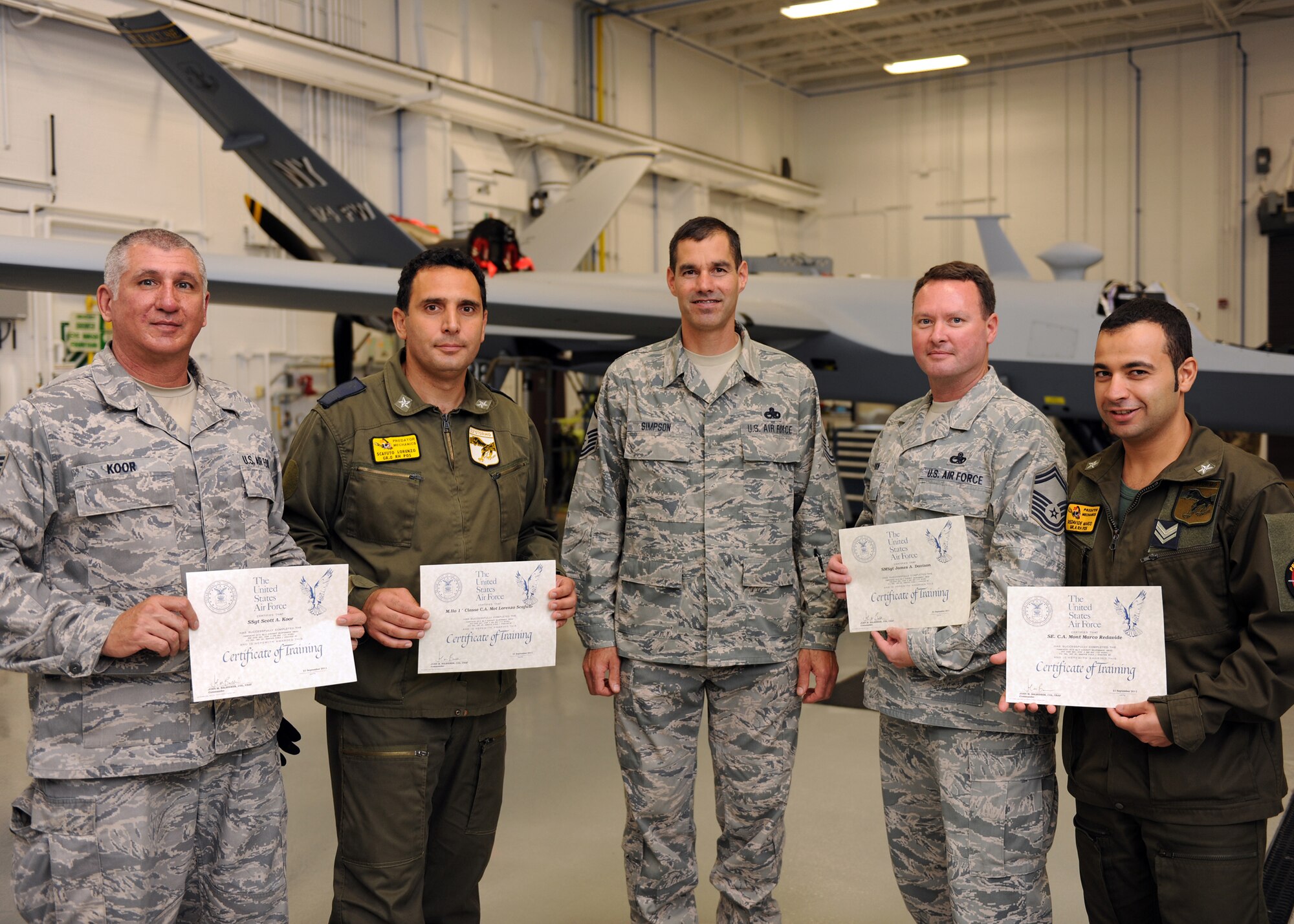 Italian Air Force Chief Warrant Officer Lorenzo Scafuto (second from left) and Staff Sgt. Marco Redavide (right), representing the first foreign military gradutates of Hancock Field's MQ-9 maintenance schoolhouse, receive certificates of training during a ceremony held in Syracuse, New York on 21 Sept 2011.  Also receiving certificates from instructor Master Sgt. Scott Simpson (center) are Senior Master Sgt. James Davison (second from right) and Staff Sgt. Scott Koor (left). This was the 100th graduating class from Hancock Field's MQ-9 Field Training Detachment. (Photo by Staff Sgt Ricky Best)