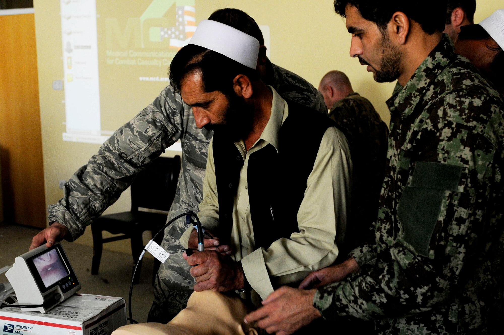 An Afghan National Army doctor talks a local Jaji district doctor through the process of intubating a patient using a lighted scope during a training class in Jaji district, Paktya Province, Afghanistan, Sept. 25, 2011. Medical care providers received training in trauma, hygiene, performing ultrasounds and various other medical procedures. (U.S. Air Force photo/Senior Airman Wesley Farnsworth)