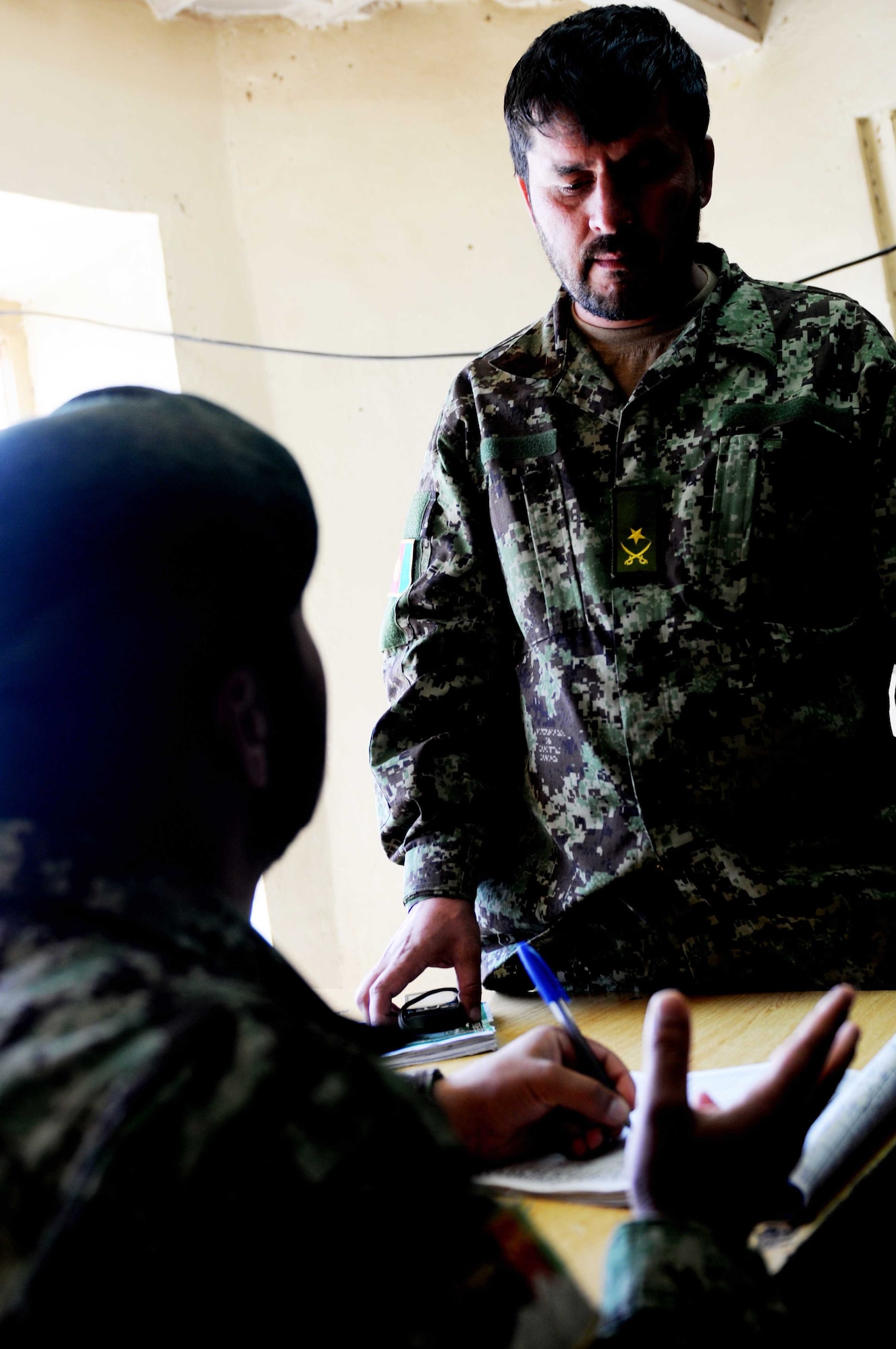 Maj. Mohammad Ahmin (right), Afghan National Army Kandak (battalion) executive officer from Mazar-i-Sharif, discusses the scheduled opening of a joint district operation center for Afghan National Police, Afghan National Army and Afghan National Civil Order Police in Paktya Province, Afghanistan, Sept 26, 2011. The center provides a central location for all Afghan security members in Zormat to coordinate and respond to emergencies, Ahmin said. (U.S. Air Force photo/1 Lt Cammie Quinn)