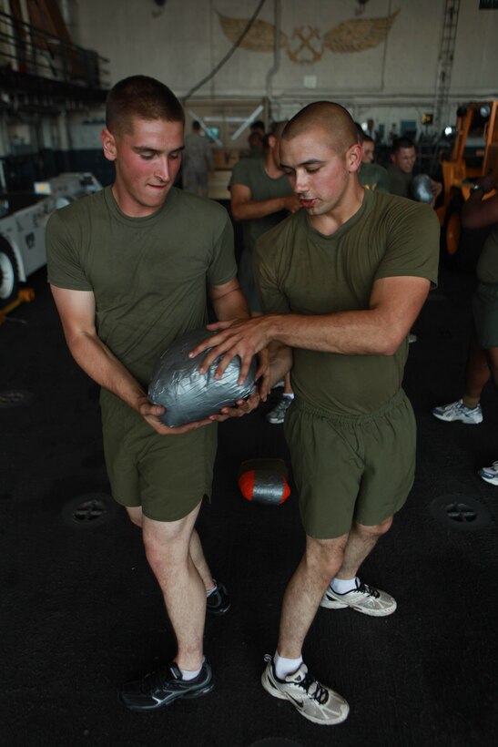 Cpl. Steven Matthews, left, and Cpl. Jared Wilson, both with the amphibious assault vehicle platoon assigned to the 11th Marine Expeditionary Unit, exercise aboard USS New Orleans here Sept. 30. The Marines boarded USS the New Orleans for their final exercise before deploying in November. Matthews, 22, hails from Milwaukee. Wilson, 21, hails from Riverside, Calif.
