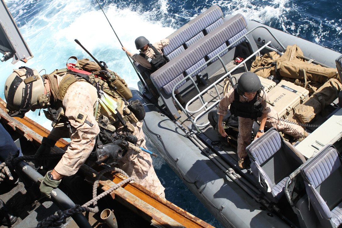 A Marine with the 11th Marine Expeditionary Unit's maritime raid force climbs aboard a Navy rigid-hulled inflatable boat during an exercise to retake a simulated pirated vessel here Oct. 1. The unit embarked the amphibious transport dock New Orleans Sept. 28 for a final exercise before deploying in November.