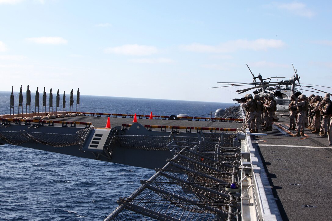 A Marine serving with the 11th Marine Expeditionary Unit's Battalion Landing Team 3/1 exercises on USS Makin Island's flight deck here Oct. 1. The unit embarked the amphibious assault ship for its final exercise before deploying in November.