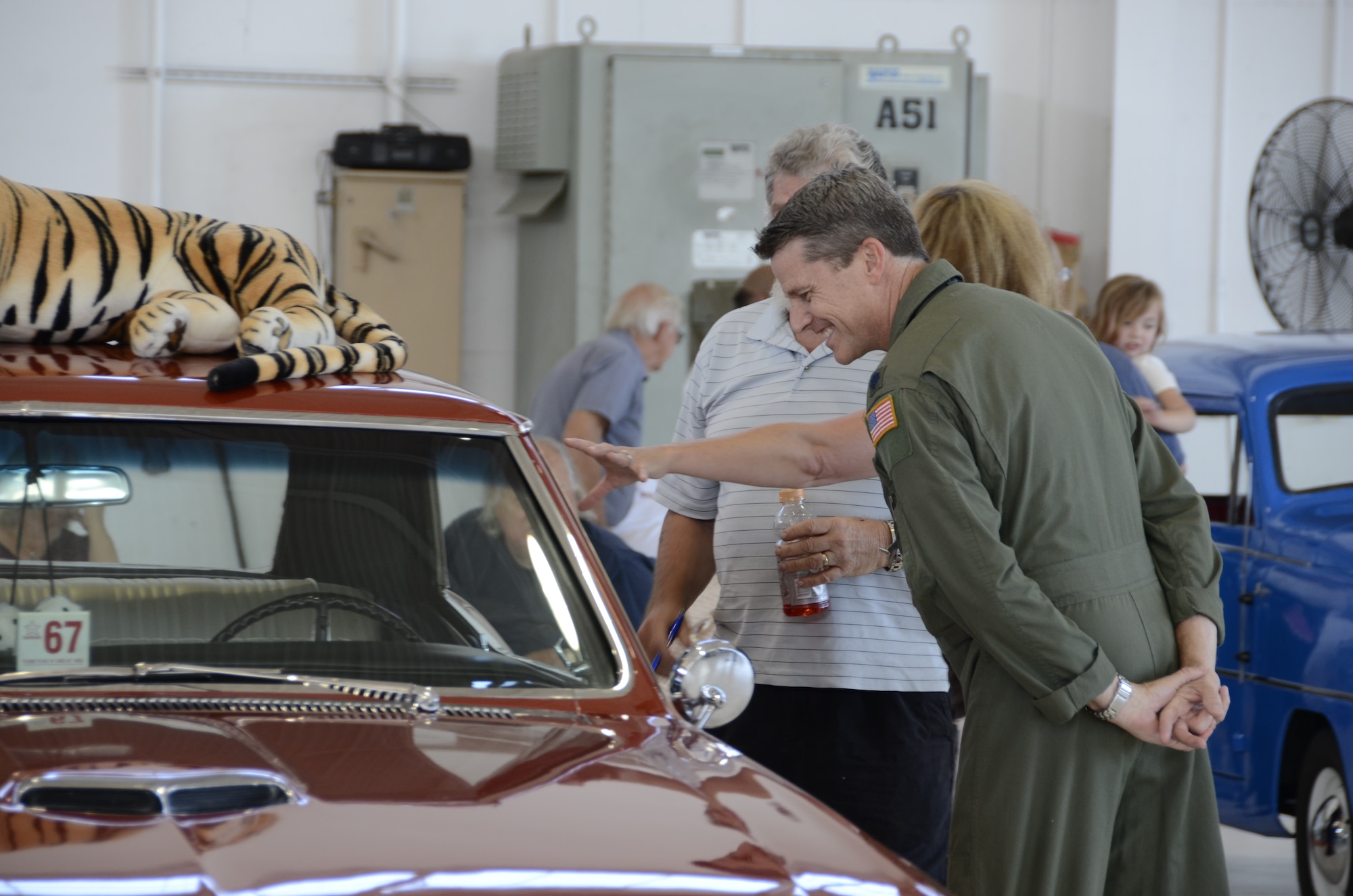 Lt Col. James Fisk, a member of the 144th  Operations Group, examines a classic car during the Oct 2, 2011 Family Day car show at the Air National Guard Base, Fresno Calif. The Family Day introduces military family members to Air Guard day to day operations and work environments along with games, food, and entertainment. (U.S. Air Force photo by Tech Sgt Robin Meredith)