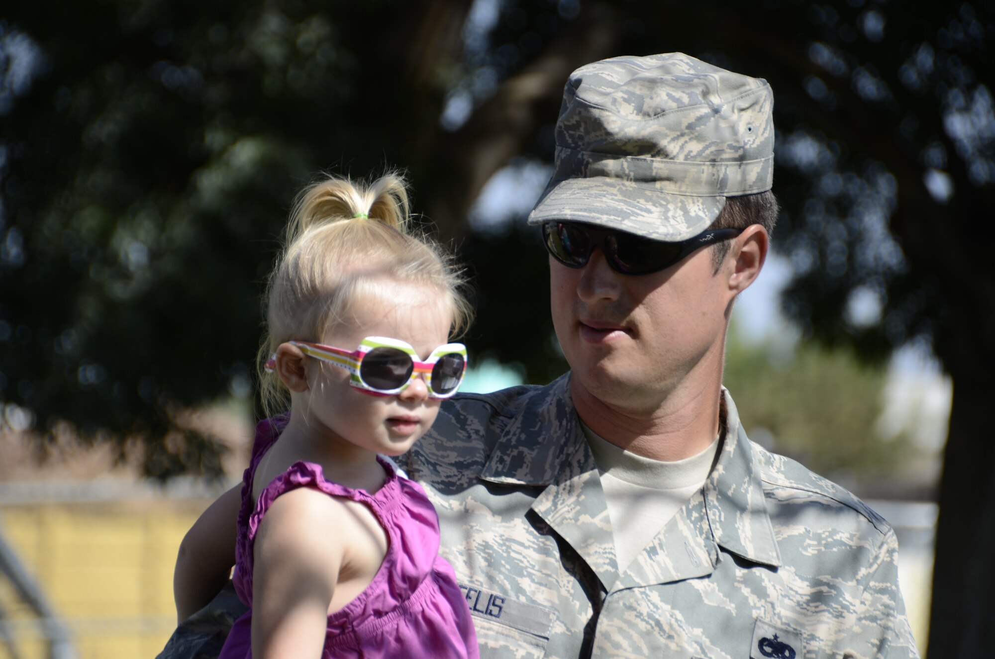 TSgt Eric Wheelis, a member of the 144th Aircraft Maintenance Squadron, and his daughter enjoy the afternoon during the Oct 2, 2011 Family Day at the Air National Guard Base, Fresno Calif. The Family Day introduces military family members to Air Guard day to day operations and work environments along with games, food, and entertainment. (U.S. Air Force photo by Tech Sgt Robin Meredith)