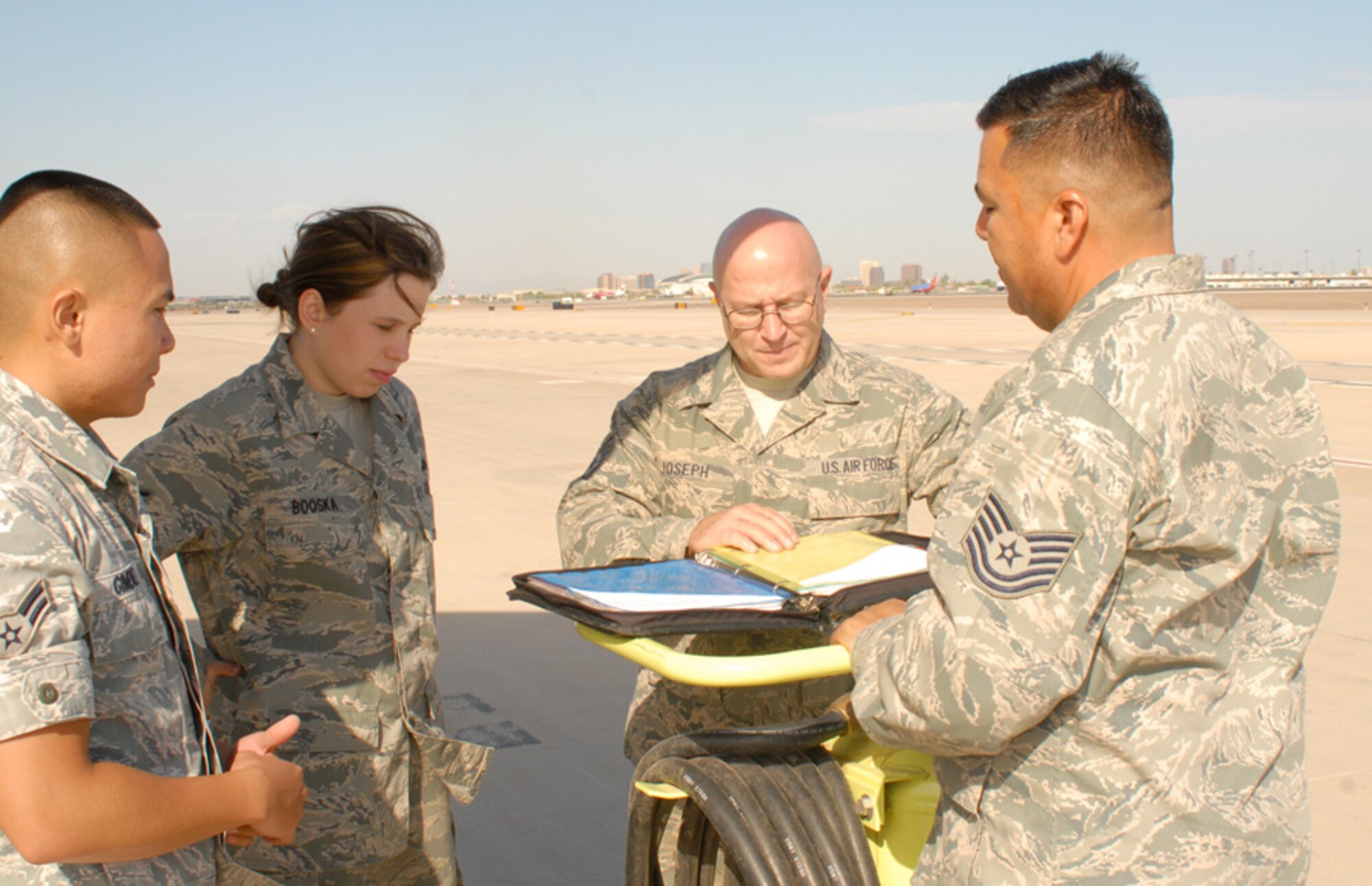 (From left) Technical Sgt. Ramiro Pacheco, Airman 1st Class Jenna Booska , Master Sgt.  Marty Corona, Staff Sgt. David Joseph , and Airman 1st Class Kevin Gimenez, 161st Maintenance Group crew chiefs, stand with their KC-135r, Phoenix, October 2011. This aircraft flew 1,070 flight hours during fiscal year 2011; aside from air refueling, missions include transporting passengers and cargo, proving to be a major contributor to mission success. (Air Force photo by A1C Rashaunda Williams/Released)