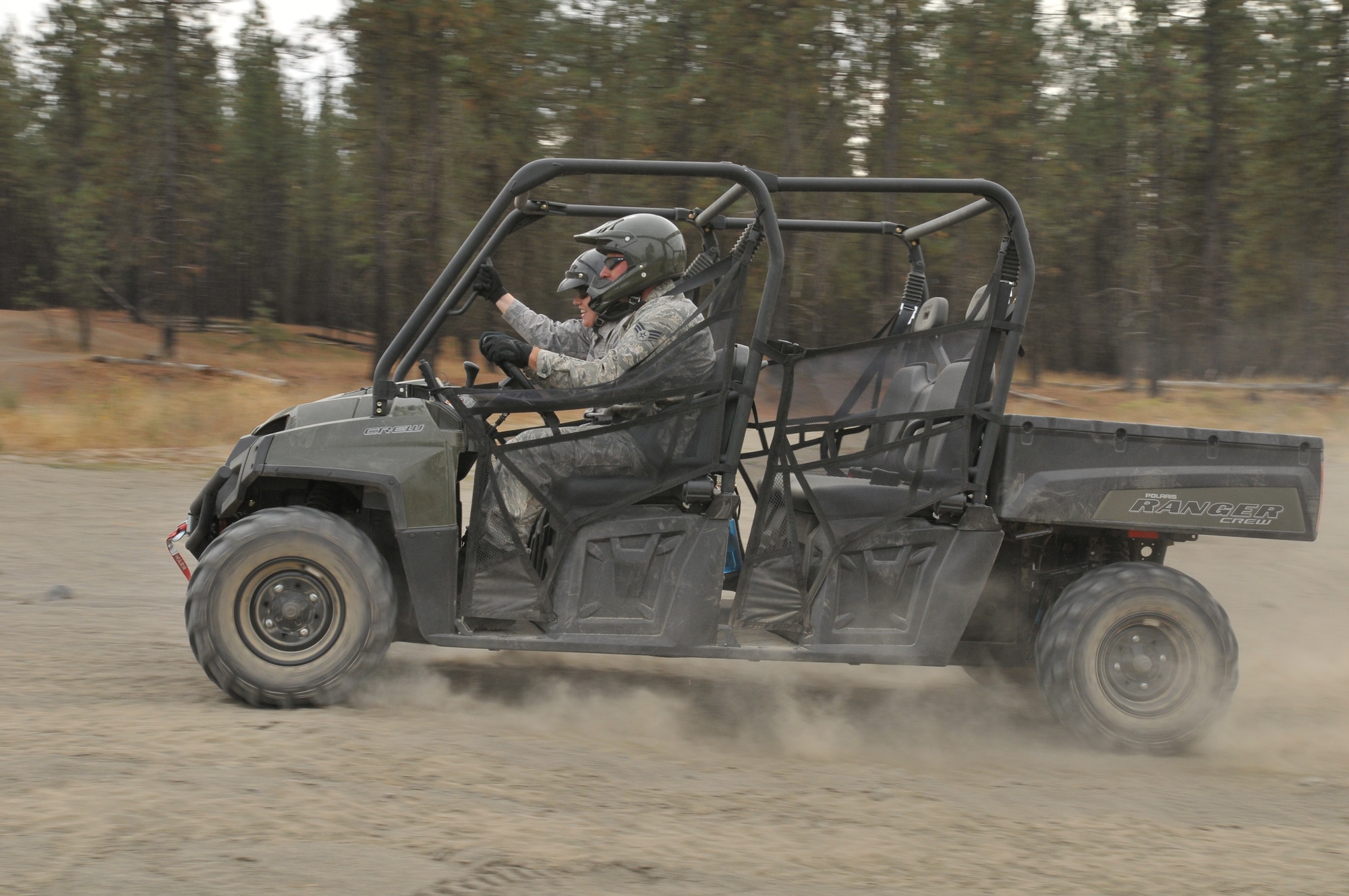 Tech. Sgt. Cynthia L. LaForce and Senior Airman Jason H. Clark from the 141st Force Support Squadron speed through an obstacle course in a new Polaris Ranger all-terrain vehicle at Seven Mile off-road vehicle Park Oct. 1 near Spokane, Wash.  The Polaris vehicles are part of the Fatality Search and Recovery Team and will be used to recover victims of natural and manmade disasters.  (U. S. Air Force Photo by Tech. Sgt. Travis S. Metheny/Released)