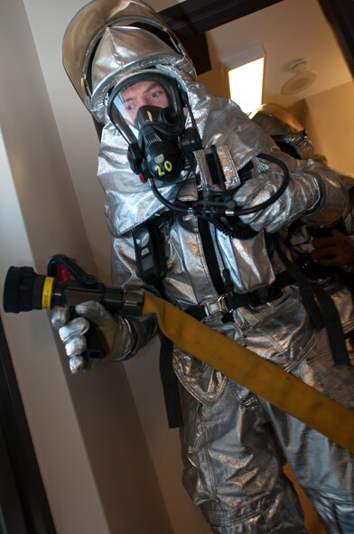 Airmen with the Missouri Air National Guard’s 139th Airlift Wing Fire Department, clear a room during a simulated structure fire on October 2, 2011 at Rosecrans Memorial Airport in Saint Joseph Mo. The fire department performs training exercises to stay current in case of a real world emergency. (U.S. Air Force photo by Senior Airman Sheldon Thompson)
