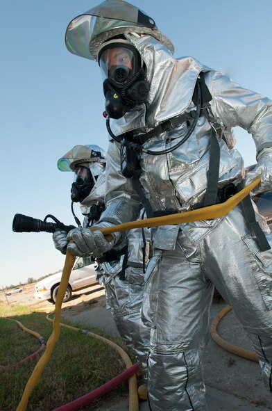 Airmen with the Missouri Air National Guard’s 139th Airlift Wing Fire Department, prepare to enter a simulated structure fire on October 2, 2011 at Rosecrans Memorial Airport in Saint Joseph Mo. The fire department performs training exercises to stay current in case of a real world emergency. (U.S. Air Force photo by Senior Airman Sheldon Thompson)