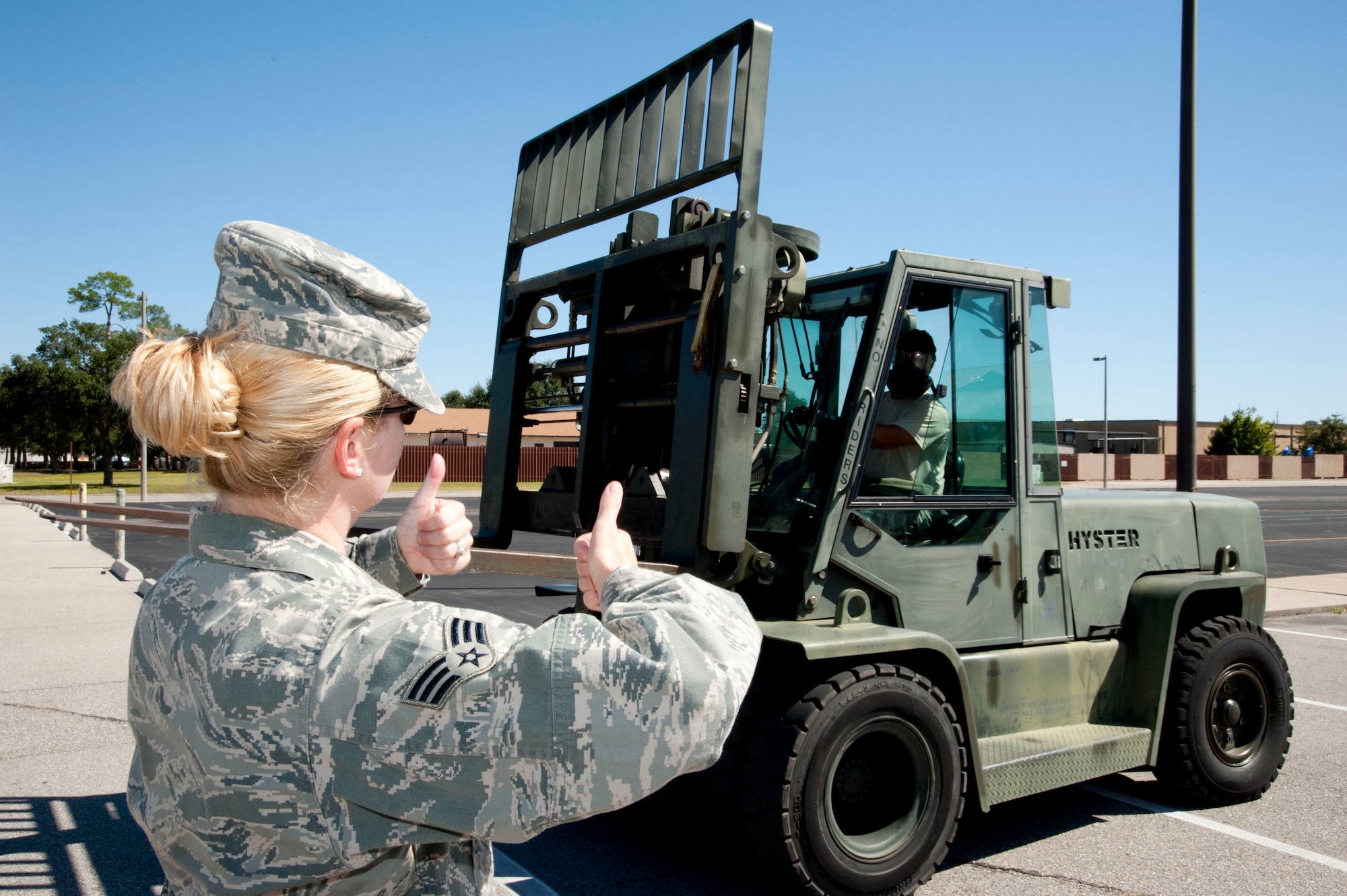 Senior Airman Marie Zieman, 403rd Civil Engineers Squadron emergency management specialist, guides Tech. Sgt. Emile Babin through a series of forklift operations during the October unit training assembly. Babin, a 403rd Aircraft Maintenance Squadron crew chief, practiced driving the forklift in gloves, boots and gas mask to test his ability to operate the vehicle during a simulated chemical warfare environment. The driving class was part of the preparation for the wing’s Operational Readiness Inspection in January 2012. (U.S. Air Force photo/Tech. Sgt. Ryan Labadens)