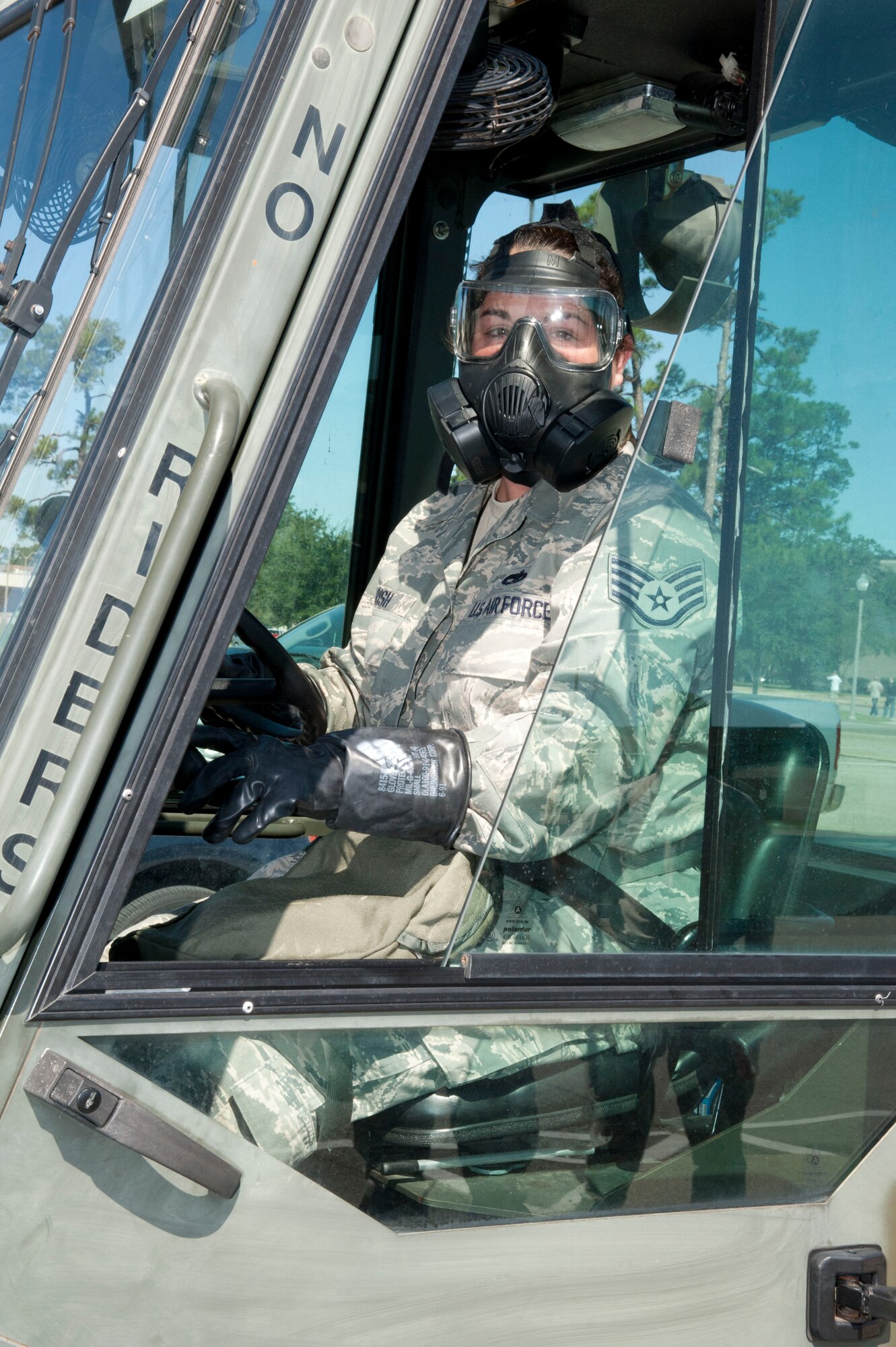 Staff Sgt. Rachel Parish, 403rd Aircraft Maintenance Squadron crew chief, practices driving a forklift in gloves, boots and gas mask during the October unit training assembly. The driving class tested the ability of wing members to operate vehicles during a simulated chemical warfare environment for the January 2012 Operational Readiness Inspection. (U.S. Air Force photo/Tech. Sgt. Ryan Labadens)