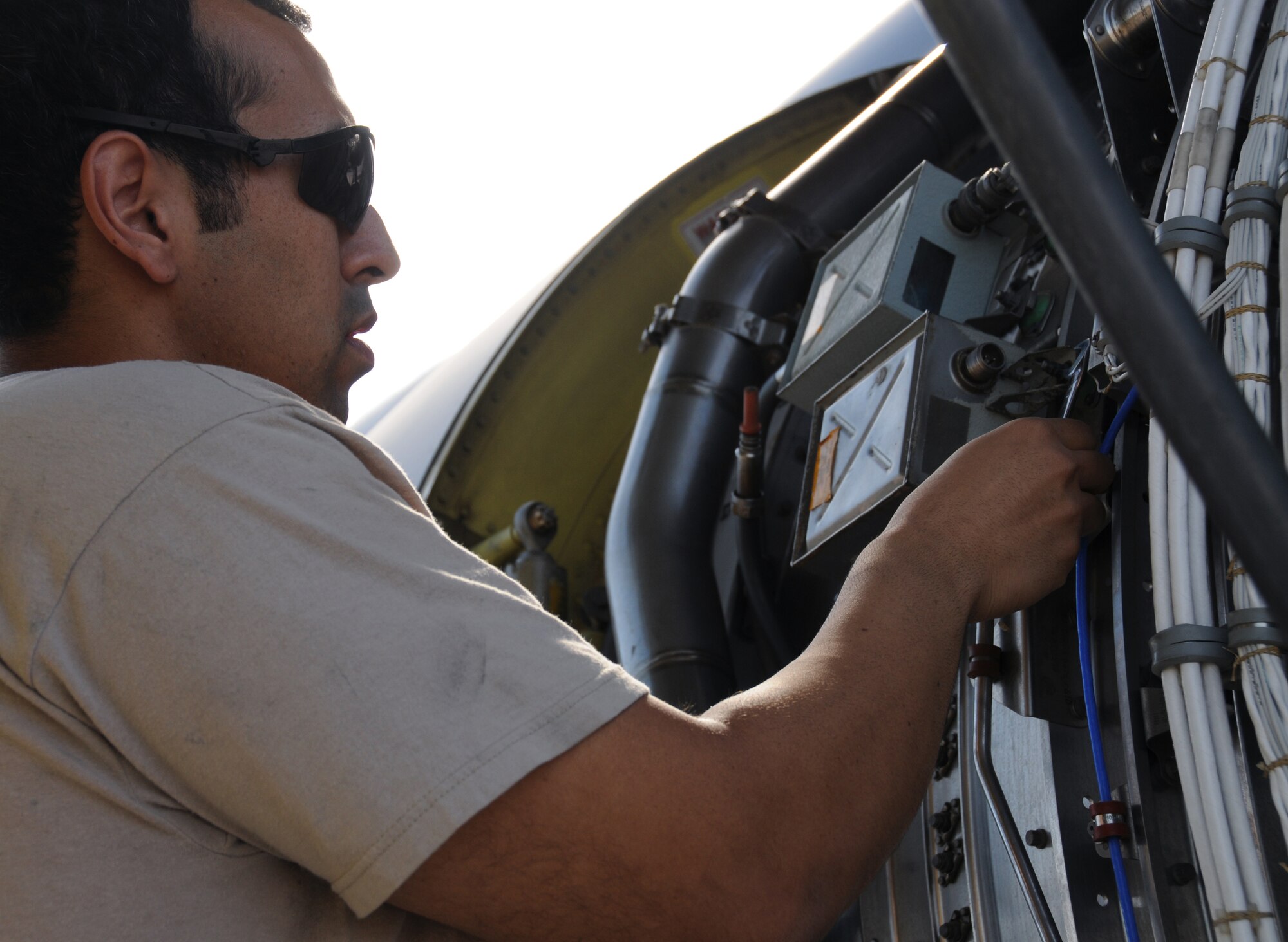 Senior Airman Guadalupe Retana, 161st Maintenance Group engine mechanic, changes out the ignition exciter box on a KC-135r as part of a routine maintenance inspection, Phoenix, Oct. 1, 2011. This scheduled maintenance includes checking all four engines, changing filters and ensuring there aren’t any oil or fuel leaks. (U.S. Air Force Photo by Staff Sgt. Courtney Enos/Released)