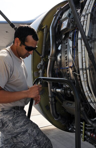 Senior Airman Guadalupe Retana, 161st Maintenance Group engine mechanic, changes out the ignition exciter box on a KC-135r as part of a routine maintenance inspection, Phoenix, Oct. 1, 2011. This scheduled maintenance includes checking all four engines, changing filters and ensuring there aren’t any oil or fuel leaks. (U.S. Air Force Photo by Staff Sgt. Courtney Enos/Released)