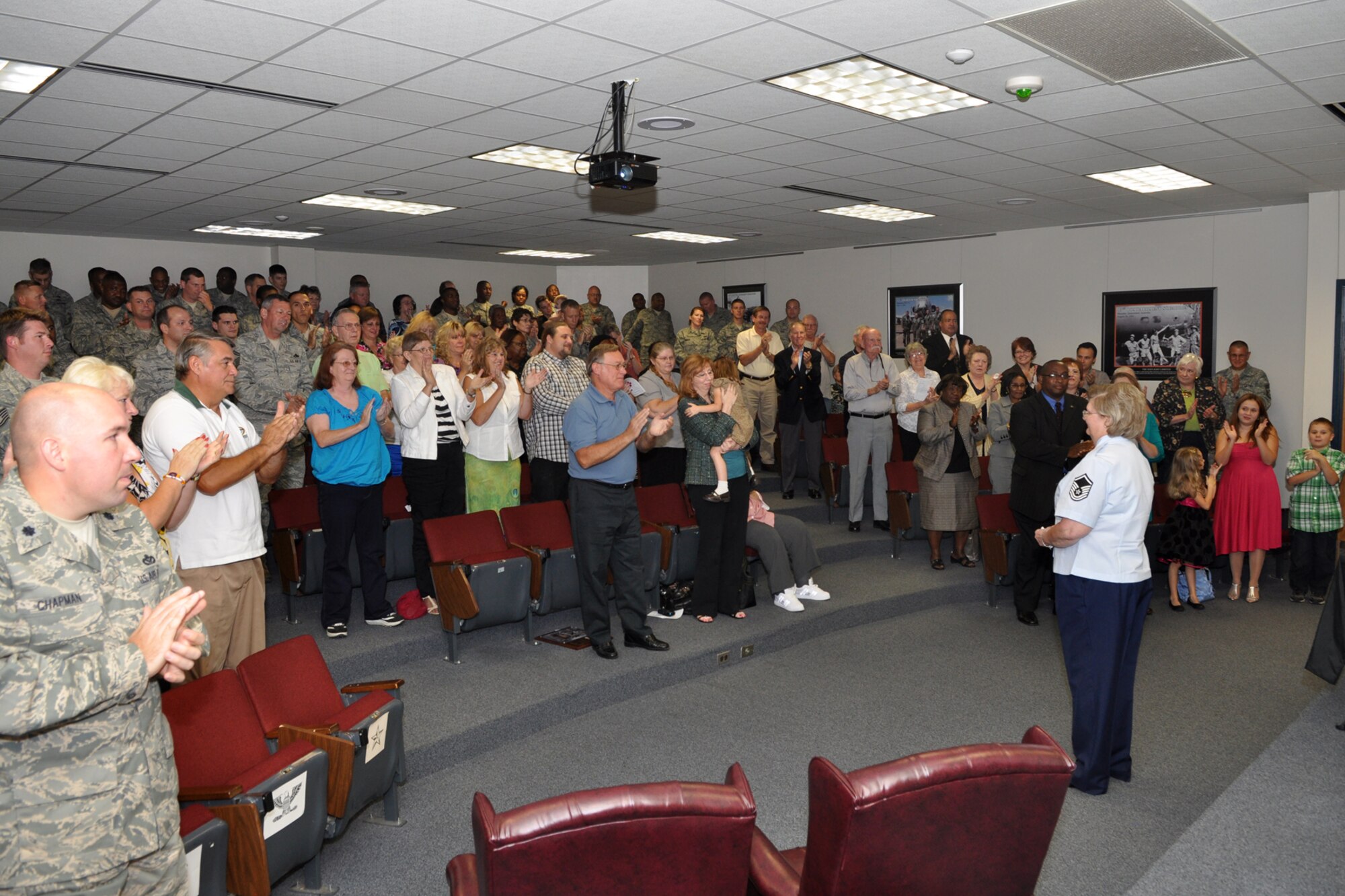 Retired Master Sgt. Naomi Soliday, receives a standing ovation during her retirement ceremony at the 307th Bomb Wing headquarters building, Oct. 1, 2011. Soliday was a member of the 307th Civil Engineer Squadron. The presiding officer for the ceremony was Maj. Michael J. Gibbons, who is a B-52 flight test evaluator radar navigator, assigned to the 10th Flight Test Squadron, Tinker Air Force Base, Okla. (U.S. Air Force photo by Master Sgt. Jeff Walston/Released)