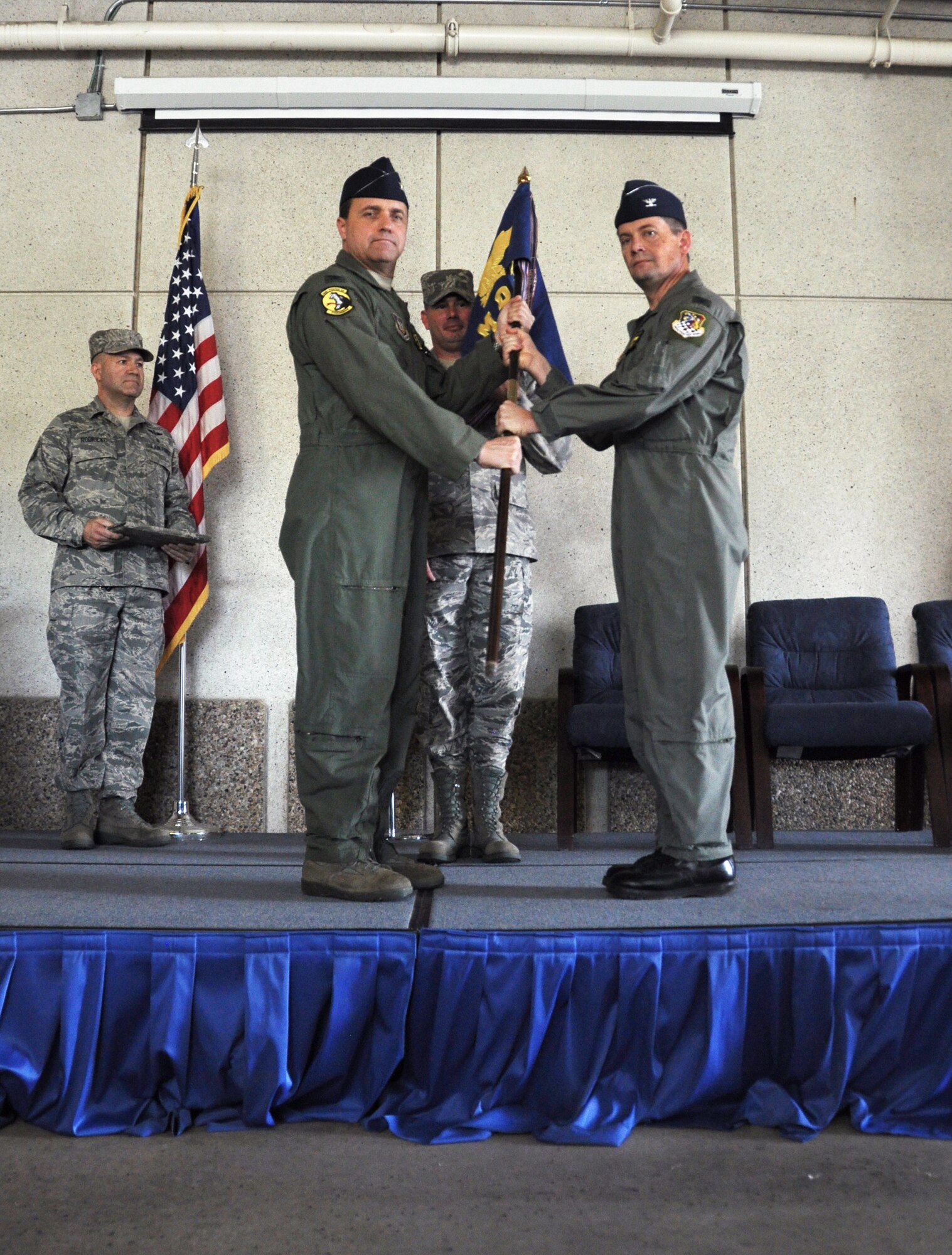 Col. Keith Knudson, 419th Fighter Wing commander, passes the 419th Medical Squadron flag to Col. Laurence Nelson during a change of command ceremony Saturday. (U.S. Air Force photo/Airman 1st Class Crystal Charriere)
