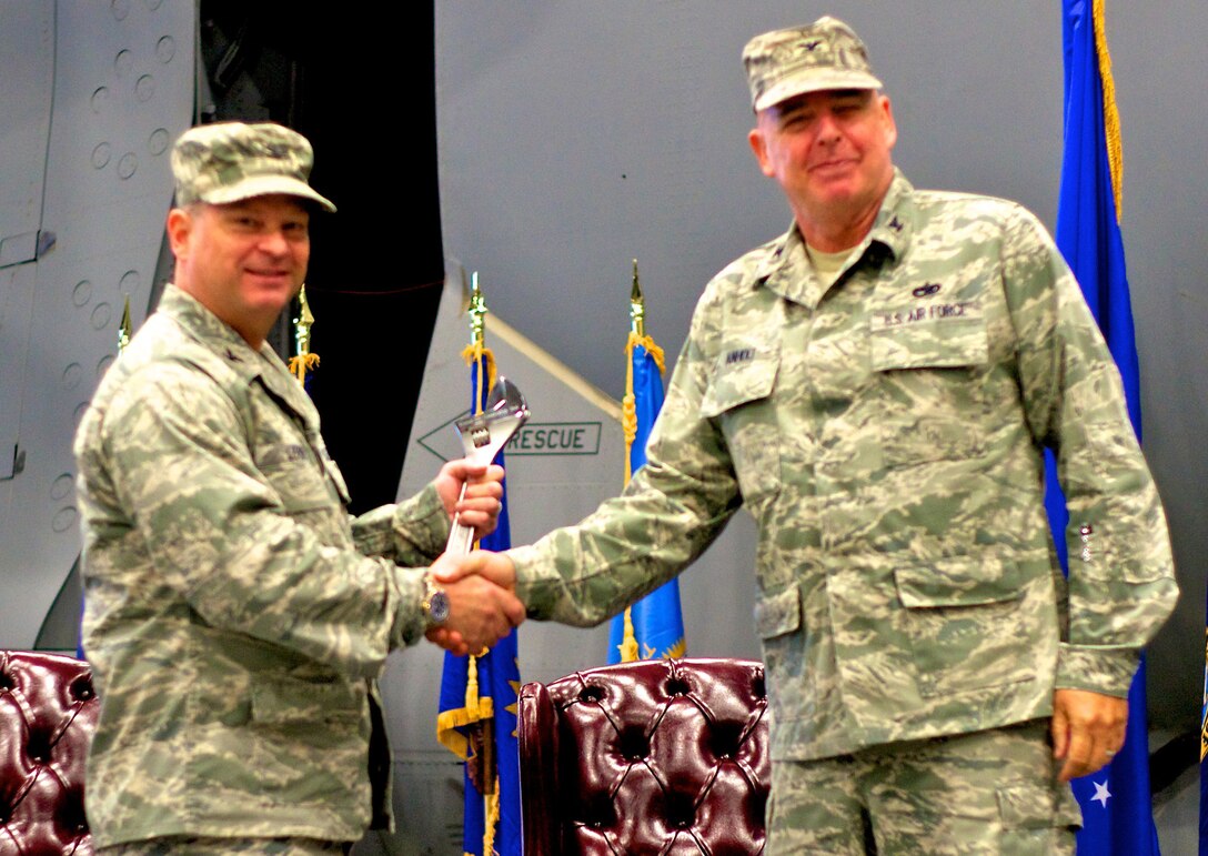Col. Alan Lerner, 446th Maintenance Group commander accepts the maintenance group wrench from former 446th MXG commander Col. William Anholt after the group change of command ceremony, Oct. 1, 2011 at McChord Field, Wash. The wrench represents the Reservists of the maintenance group. (U.S. Air Force photo by Staff Sgt. Newton Nagata)                    