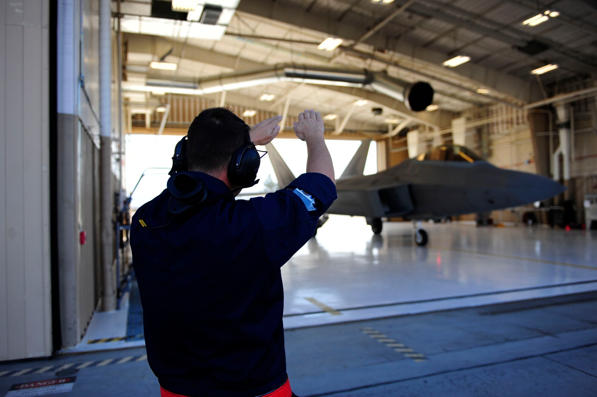 Staff Sgt. Philp Philipson marshals an F-22 Oct. 1. The F-22s, grounded by Air Force officials, have resumed flying operations at Holloman. During the stand down, maintainers performed maintenance and repairs on Holloman’s fleet of about 20 Raptors.