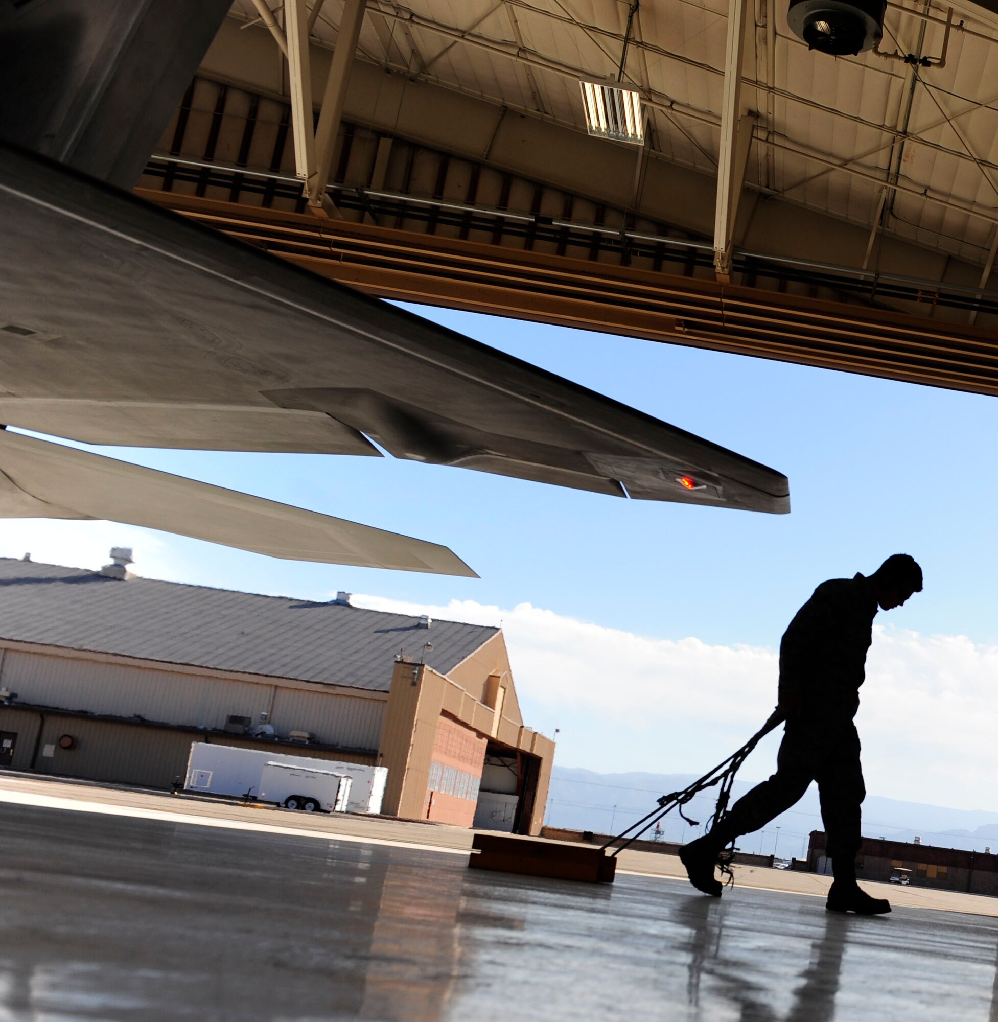 A 44th Fighter Group maintainer pulls chocks on an F-22 Oct. 1. For the first time in four months, Reservists are supporting flying operations. The commander of Air Combat Command directed a stand-down of the fleet May 3 as a safety precaution, following 12 separate reported incidents where pilots experienced hypoxia-like symptoms.  About 20 aircraft at Holloman were grounded.