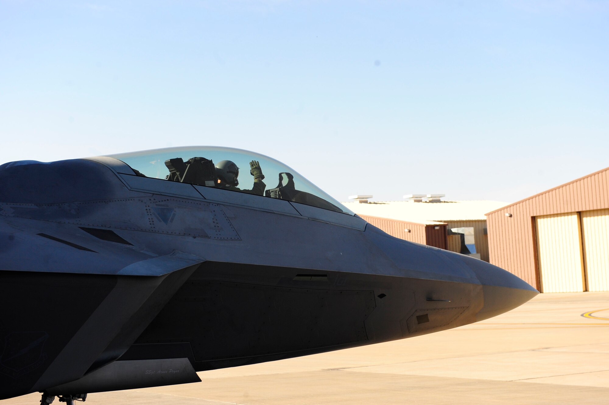 Capt. Bryan Dick returns salute as he taxis out an F-22. Air Force officials approved an implementation plan that will allow the F-22 Raptor to resume flight operations.  All Air Force F-22s, including about 20 aircraft at Holloman were grounded four months because there were reported incidents of pilots experiencing hypoxia-like symptoms.