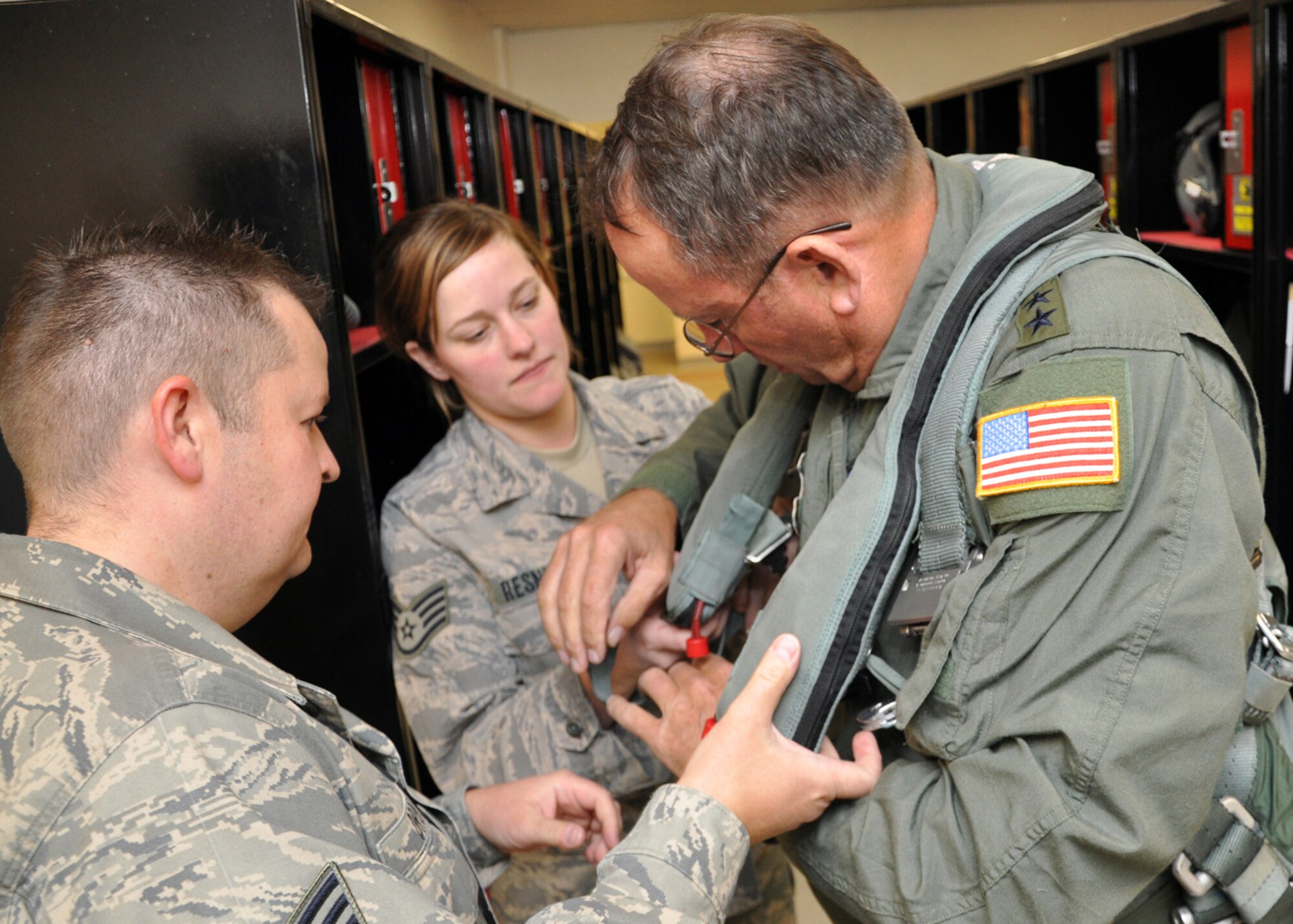 Staff Sgt. Kellie Resnick and Staff Sgt. Michael Drope, of the 419th Fighter Wing aircrew flight equipment shop, help Utah National Guard Adjutant General, Major General Brian Tarbet, suit up prior to his F-16 familiarization flight yesterday. Before the flight, Tarbet spent some time talking with 419th Airmen and learning more about the wing’s mission and routine training operations at the Utah Test and Training Range. (U.S. Air Force photo/Tech. Sgt. Richard Gonzales)
