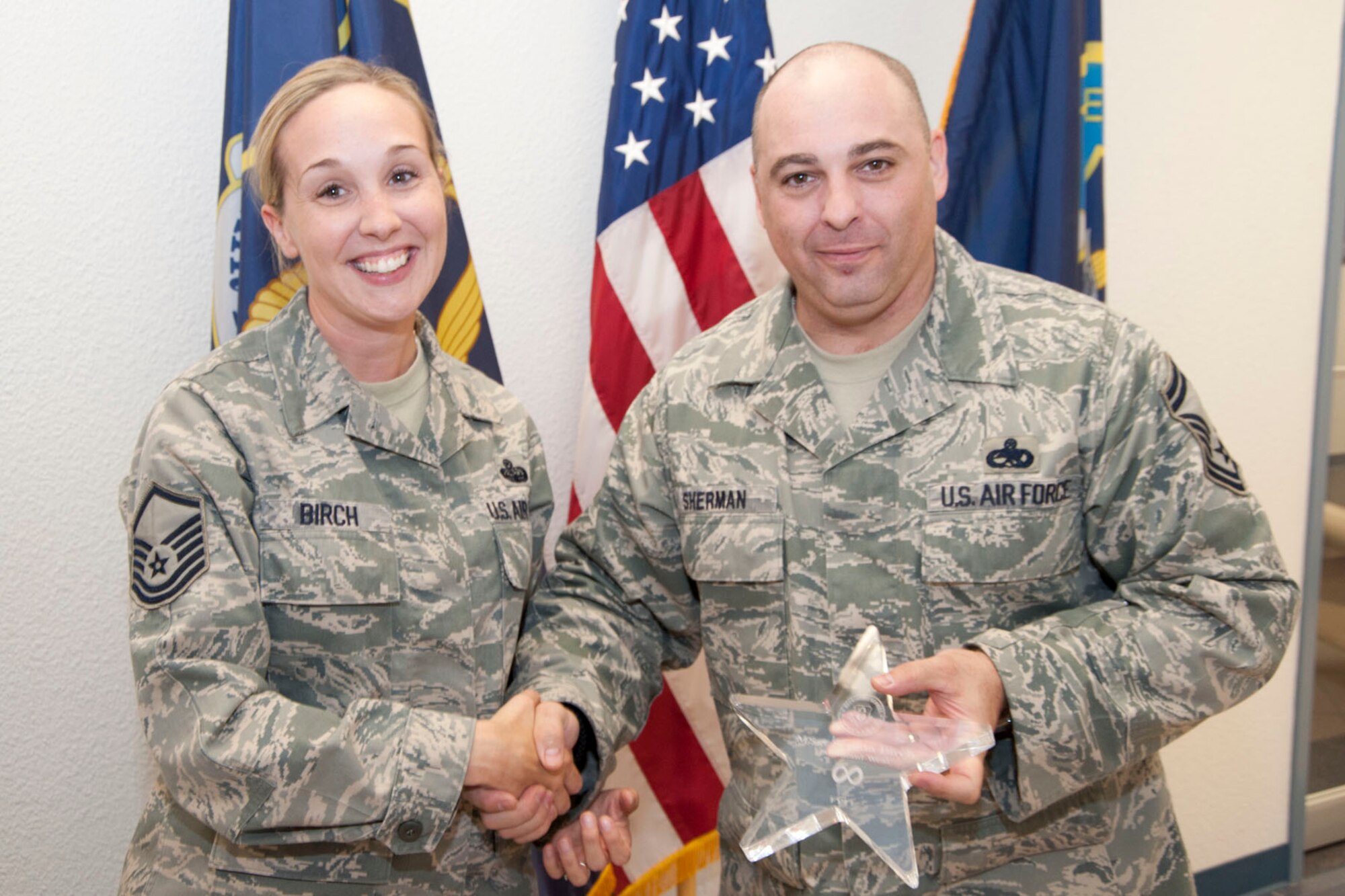 Master Sgt. Serena Birch, 403rd Wing recruiter, accepts the Infinity Award Oct. 1 from Senior Master Sgt. Neil Sherman, 403rd Wing senior recruiter. Birch technically didn’t have a recruiting goal for the fiscal year, since she just completed recruiting school this August. But she recently enlisted her first troop to the 403rd, which earned her the “all-in-fun” Infinity Award. (U.S. Air Force photo/Tech. Sgt. Ryan Labadens)