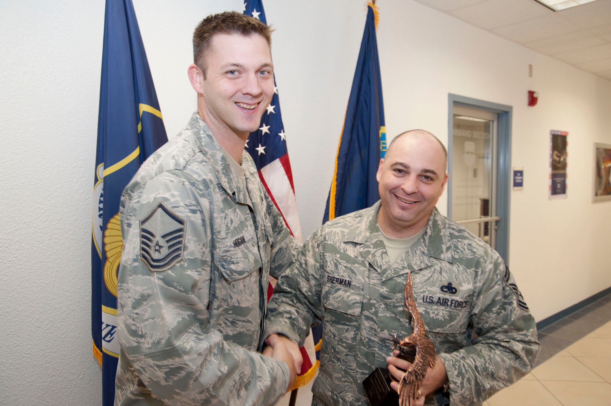 Master Sgt. Shane Hogan, 403rd Wing recruiter, accepts the Top Percentage Over Goal Award Oct. 1 from Senior Master Sgt. Neil Sherman, 403rd Wing senior recruiter. This annual award was presented to Hogan for achieving 1200 percent over his enlistment goal for fiscal year 2011. (U.S. Air Force photo/Tech. Sgt. Ryan Labadens)