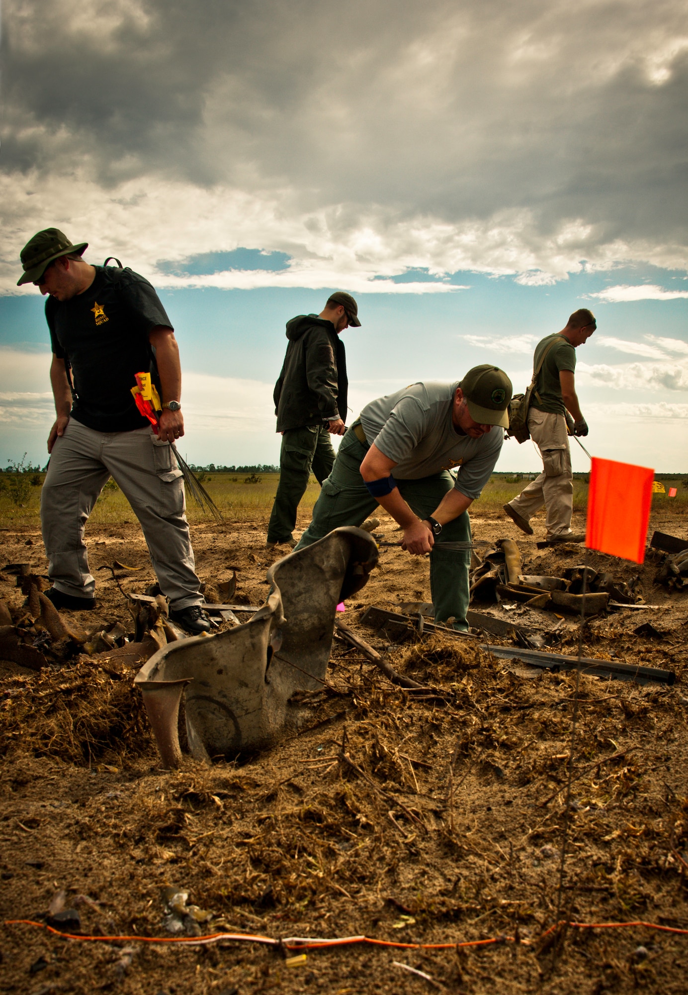 Students scavenge the post-blast scene for evidence and clues as to the cause of the explosion Sept. 28 on the Eglin Air Force Base range.  The investigation was part of the FBI's large vehicle post blast school attended by state and local law enforcement agencies as well as Navy and Air Force explosive ordnance disposal technicians. Three vehicles were blown up to create the crime scenes that students would investigate. The week-long course was the second held on Eglin with 67 students representing 18 different U.S. agencies. (U.S. Air Force photo/ Samuel King Jr.)