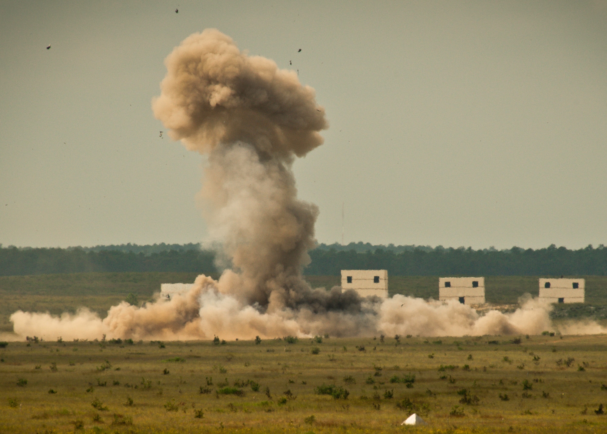 A cloud of heat and smoke erupts from the wreckage after a 1,500 pound explosive detonated Sept. 27 on the Eglin Air Force Base range.  The controlled explosion was to set a scene for the FBI’s large vehicle bomb post-blast school this week. State and county law enforcement, along with Navy and Air Force explosive ordnance disposal technicians, learned the proper procedures to investigate and maintain a large scale vehicle explosion. The week-long course was the second held on Eglin with 67 students representing 18 different U.S. agencies. (U.S. Air Force photo/Samuel King Jr.)