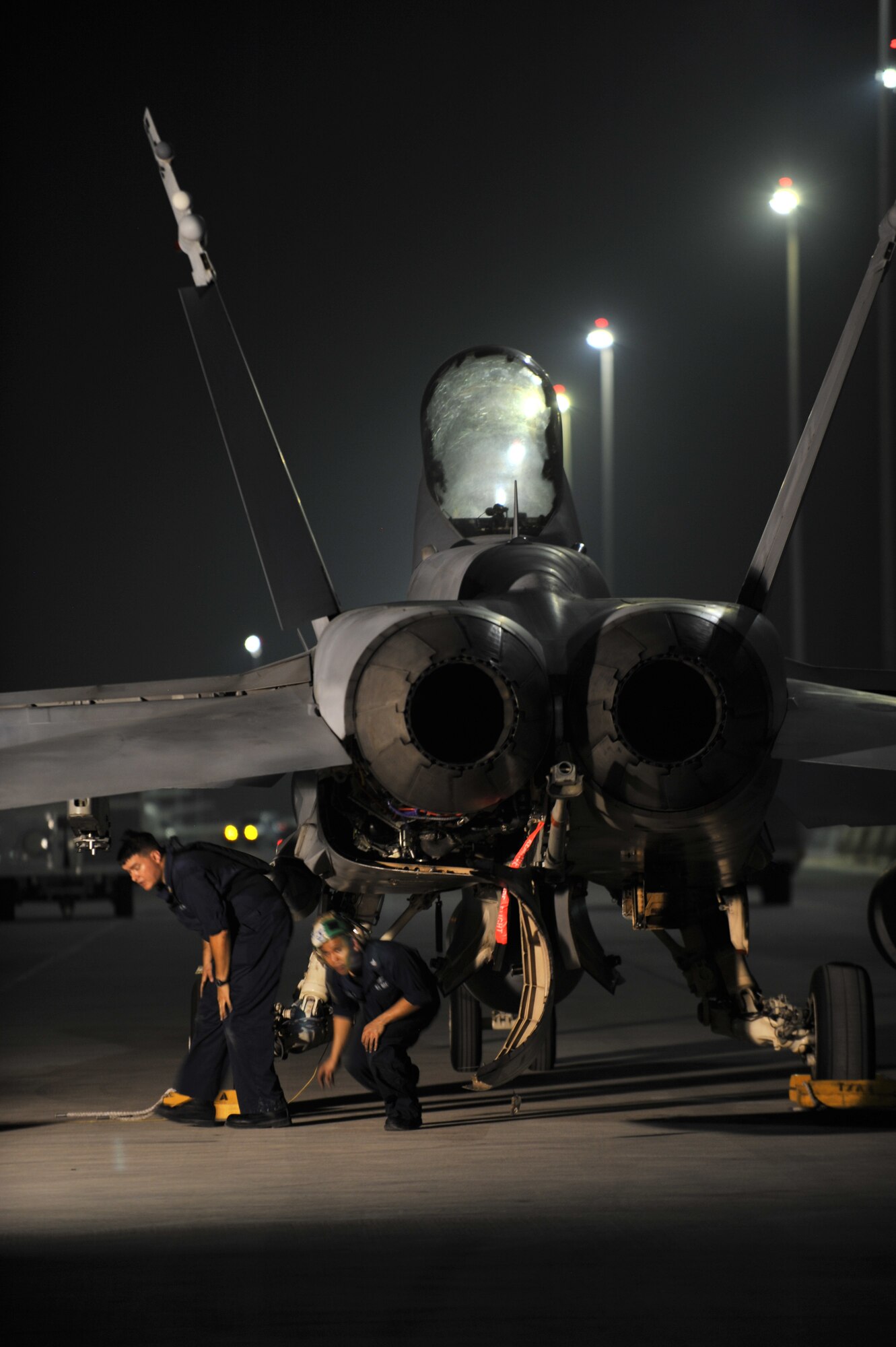 Aviation Machinist’s Mate First Class Jason Chadderton (left) and Aviation Machinist’s Mate Second Class Reumel Castillo inspect an F/A-18C Hornet, Sept. 28, 2011, at an undisclosed location in Southwest Asia. The Sailors, stationed aboard the USS John C. Stennis (CVN 74), are assigned to Carrier Air Wing (CVW) 9 embarked aboard Stennis and home based at Naval Air Station Lemoore, Calif. Chadderton is a native of Las Vegas, Nev., and Castillo is a native of San Diego, Calif. (U.S. Air Force photo/Senior Airman Paul Labbe)