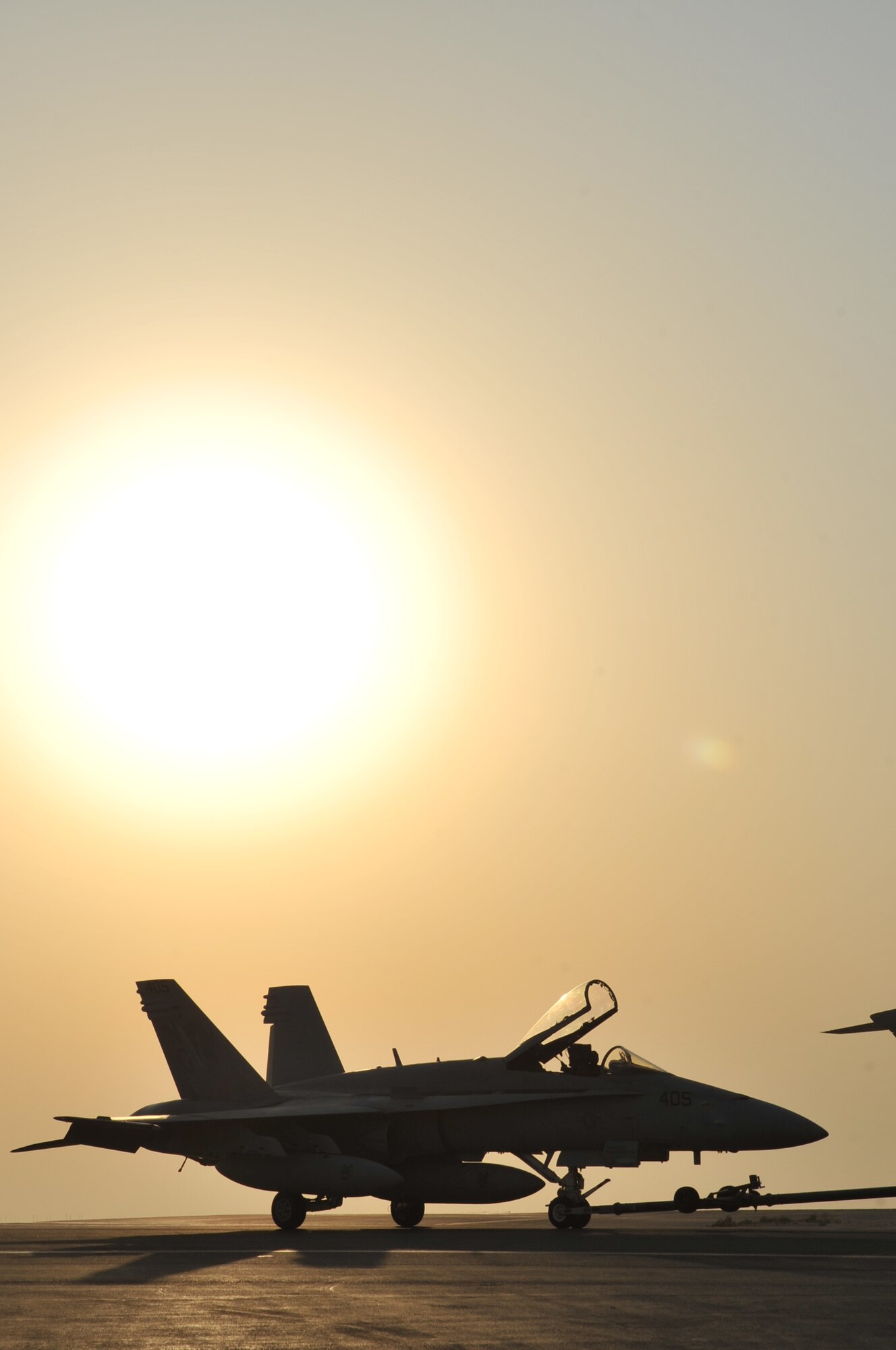 A Navy F/A-18 Hornet from USS John C. Stennis (CVN 74) is towed across the flightline Sept. 28, 2011, at an undisclosed location in Southwest Asia. (U.S. Air Force photo/Senior Airman Paul Labbe)
