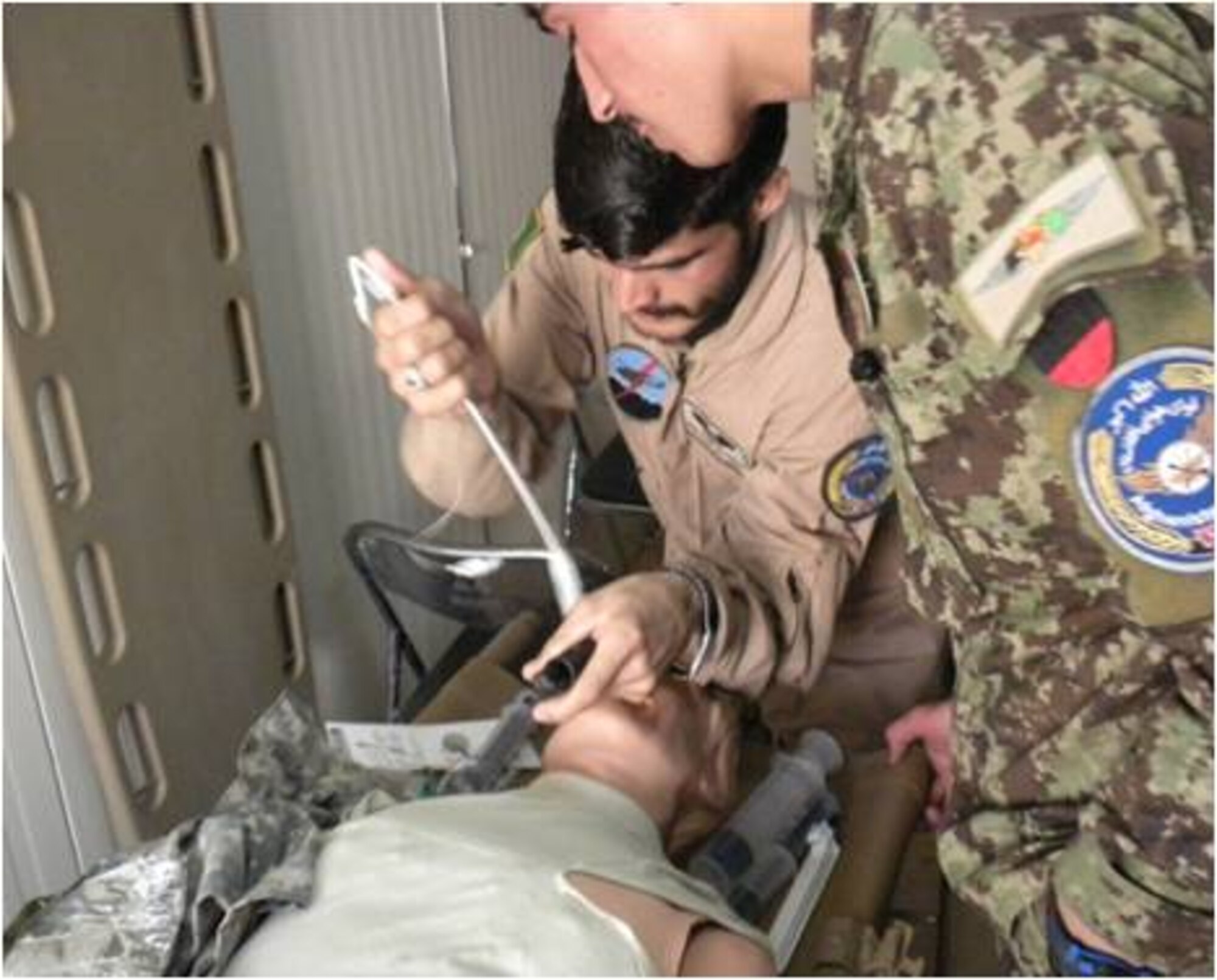 Members that attended the Afghan Air Force advanced medic course, prepare a simulated patient for a medical procedure at Kandahar Airfield recently. The students took part in the class that officials explained aimed at providing the same expertise intermediate emergency medical technicians and paramedic teams learn in the U.S.  (U.S. Air Force courtesy photo)