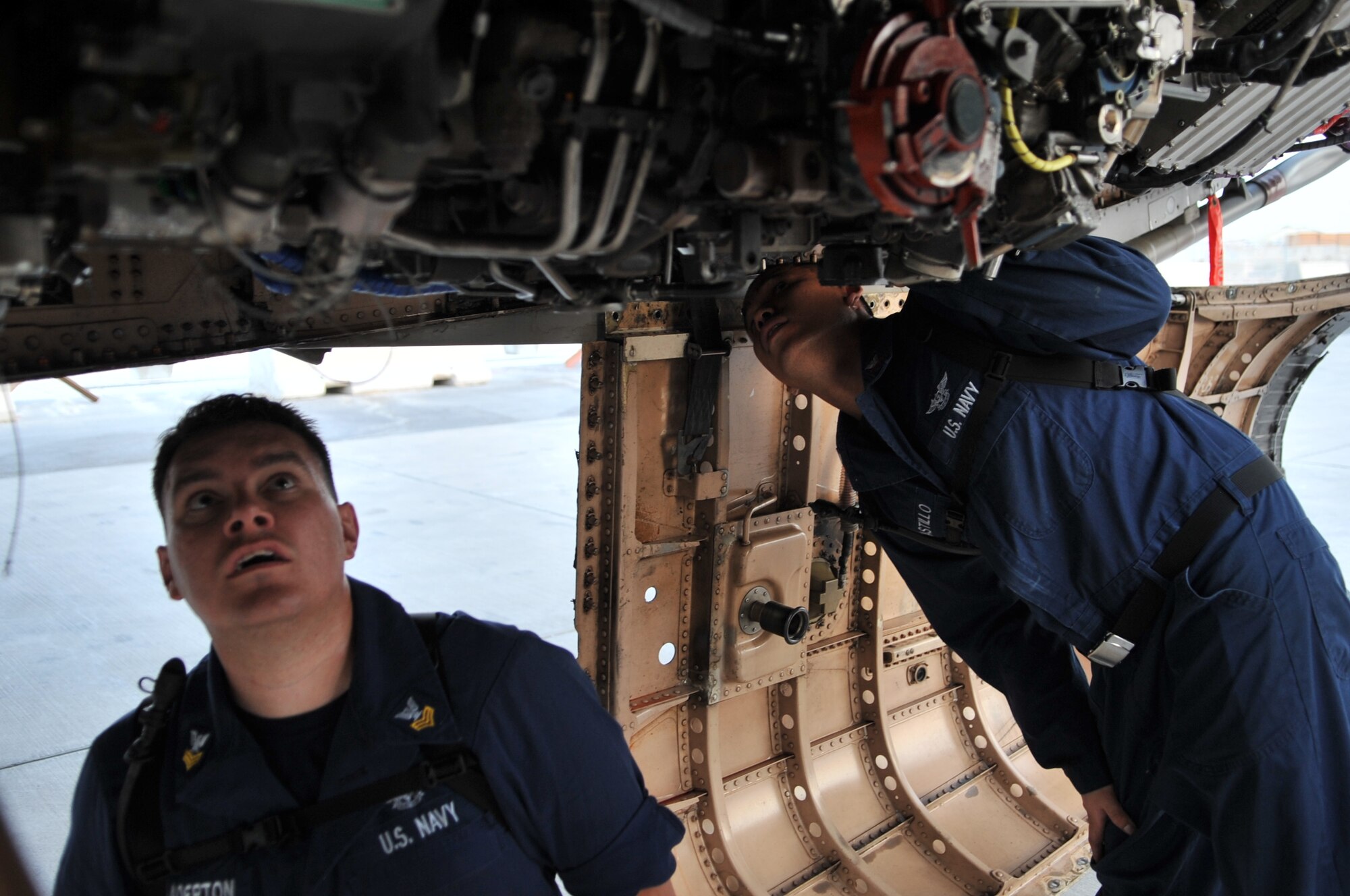 Aviation Machinist’s Mate First Class Jason Chadderton (left) and Aviation Machinist’s Mate Second Class Reumel Castillo inspect the engine of a Navy F/A-18C Hornet, Sept. 28, 2011, at an undisclosed location in Southwest Asia. The Sailors are stationed aboard USS John C. Stennis (CVN 74). Chadderton, a native of Las Vegas, Nev., and Castillo, a native of San Diego, Calif., are assigned to Carrier Air Wing (CVW) 9 embarked aboard Stennis and home based at Naval Air Station Lemoore, Calif. (U.S. Air Force photo/Senior Airman Paul Labbe)