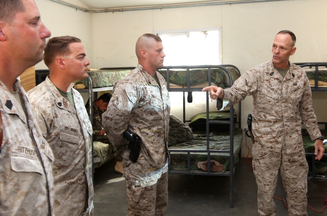 Sgt. Maj. William Stables, 2nd Marine Logistics Group (Forward) sergeant major, utilizes members of 2nd MLG (FWD)'s Embedded Partner Team to highlight their differences and similarities during a discussion on values with members of the Afghan National Army's 215th Corps Logistics Battalion at Camp Shorabak, Afghanistan, Oct. 3. During a non-commissioned officer leadership seminar, he noted the importance of knowing their troops and that regardless of their differences it is the NCOs' job to bring everyone together. (U.S. Marine Corps photo by Sgt. Justin J. Shemanski)