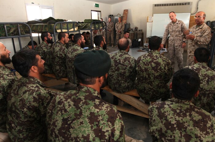 Through the use of an interpreter (right), Sgt. Maj. William T. Stables (second from right), the sergeant major for 2nd Marine Logistics Group (Forward), discusses the principles of being an effective non-commissioned officer to approximately 20 NCOs from the Afghan National Army's 215th Corps Logistics Battalion at Camp Shorabak, Afghanistan, Oct. 3. Stables touched on several hallmarks of Marine Corps leadership to include values, communication, understanding and respect. (U.S. Marine Corps photo by Sgt. Justin J. Shemanski)