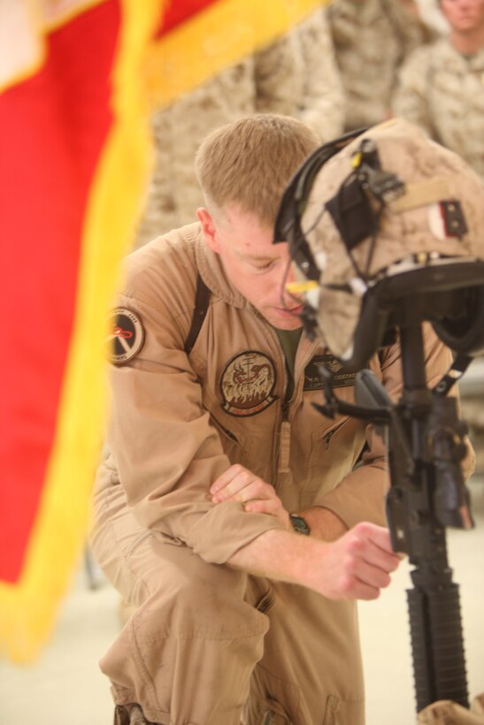 Capt. Scott Neidecker, an AH-1W Super Cobra pilot with Marine Light Attack Helicopter Squadron 269, kneels in prayer next to a memorial display for Capt. Ryan Iannelli at the chapel on Camp Dwyer, Afghanistan, Oct. 3. Iannelli, a Super Cobra pilot with the squadron, and a native of East Greenwich Township, N.J., died Sept. 28 supporting combat operations in Helmand province, Afghanistan. “Whether you knew him for five minutes or five years, he impacted you in a positive way,” said Neidecker of Iannelli. “He was the kind of guy who would do anything for anyone.”