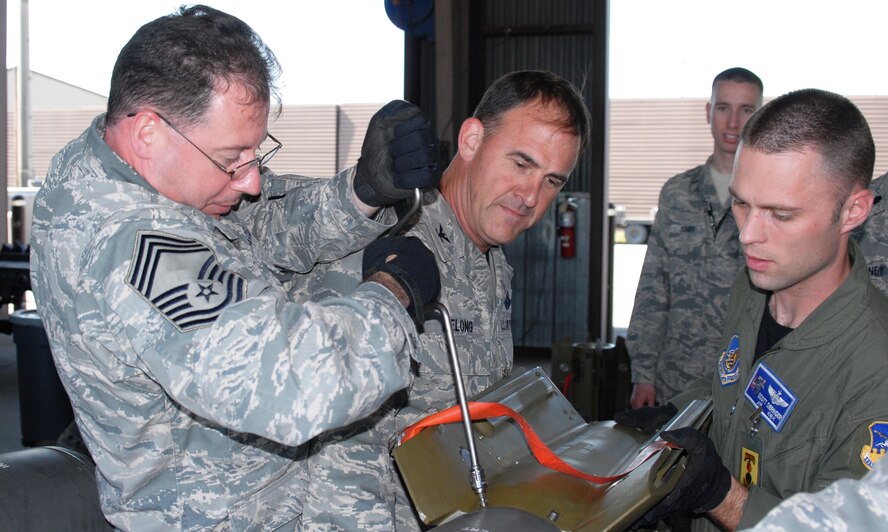 Chief Master Sgt. Richard Vogel, 51st Medical Group superintendent; Col. Mark DeLong, 51st Fighter Wing vice commander; and Capt. Jeremy Dieringer, 36th Fighter Squadron; attach a tail section to a 500-pound practice bomb Sept. 27, 2011, during a 51st Fighter Wing leadership immersion tour. Four groups of commanders, superintendents and first sergeants participated in the hands-on, assembly process under the guidance of Airmen assigned to the 51st Munitions Squadron. The intent of the day-long experience was deeper understanding of the broader mission and expertise of Airmen assigned to Osan Air Base.  (Air Force photo/Senior Master Sgt. Stuart Camp)